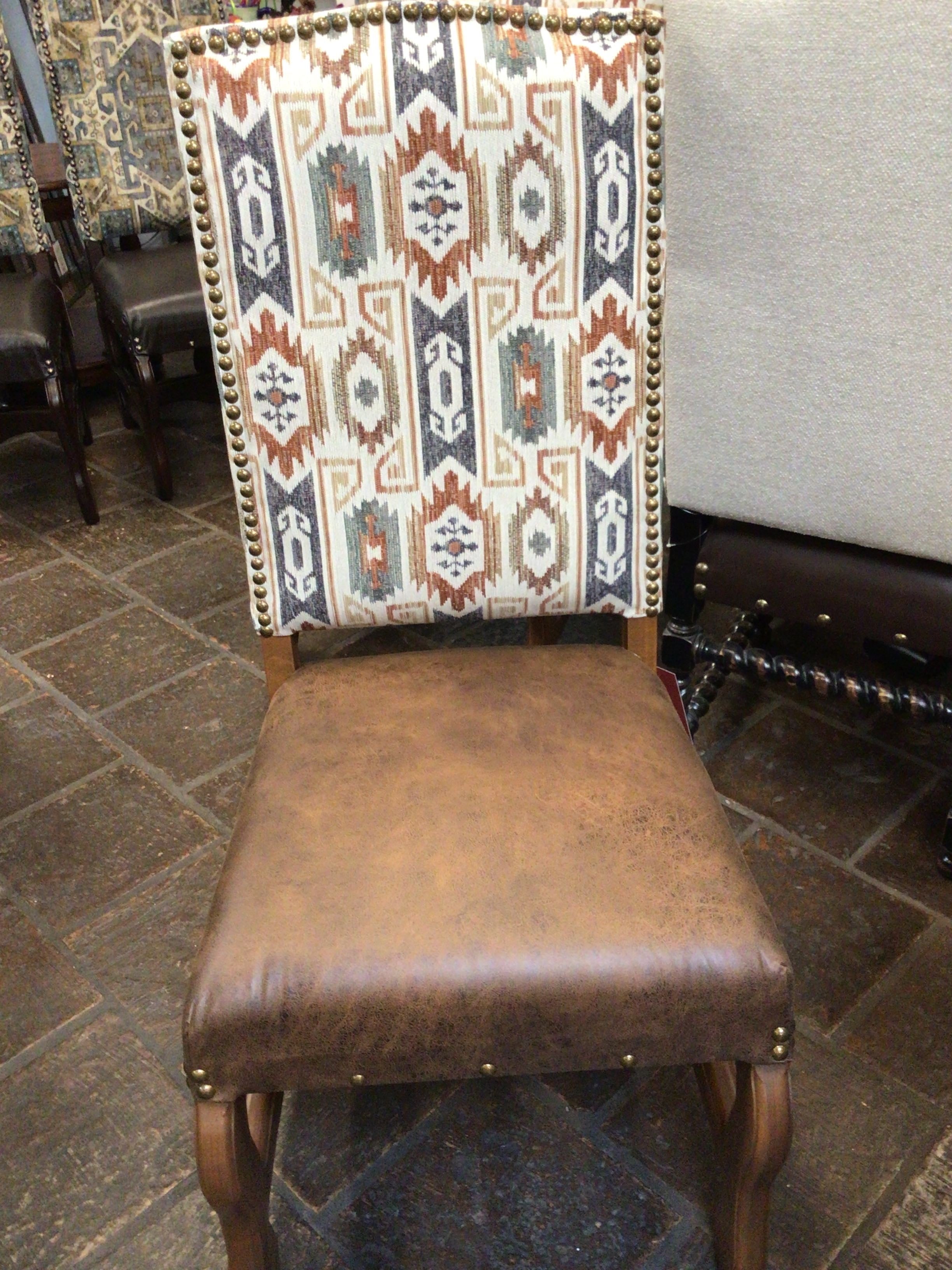 Chair with patterned backrest and brown seat in a room setting