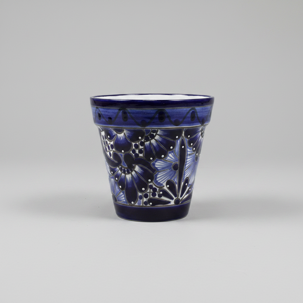 Ceramic tumbler with blue floral design on a gray background