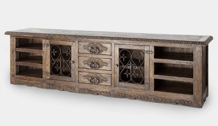 Wooden entertainment console with decorative elements on a white background