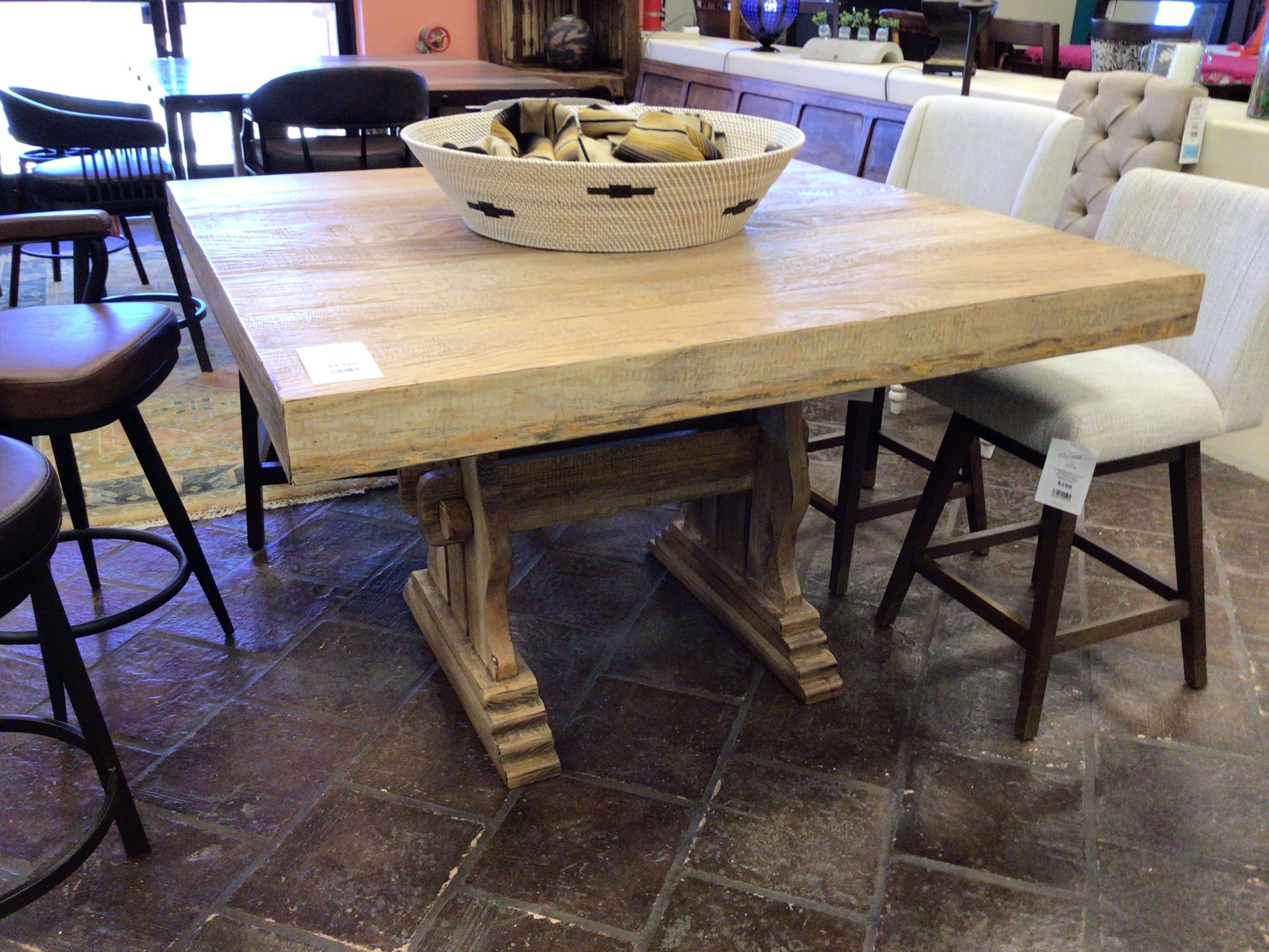 Wooden dining table with chairs in a showroom setting