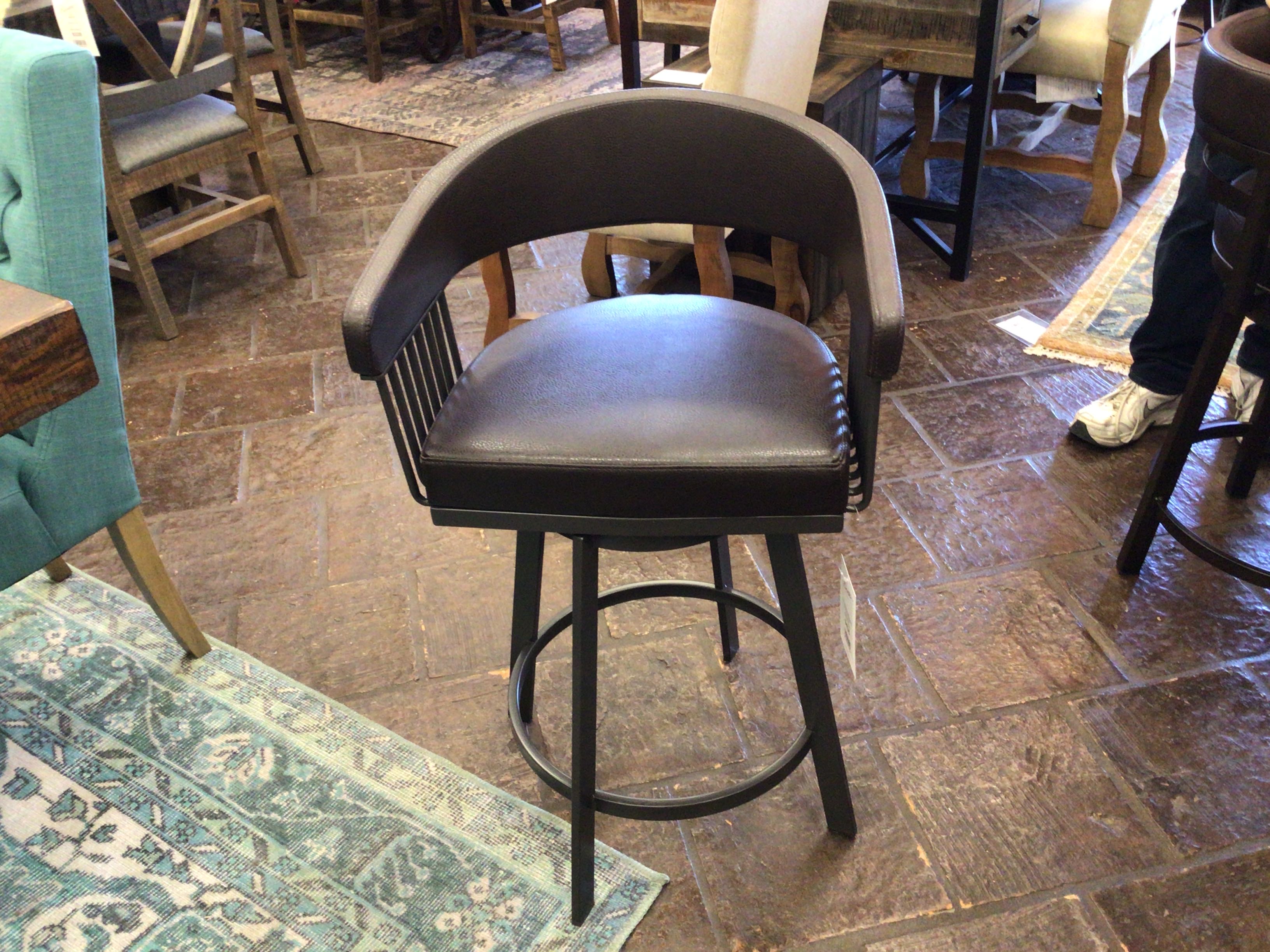Bar stool with brown seat and backrest on a stone floor.