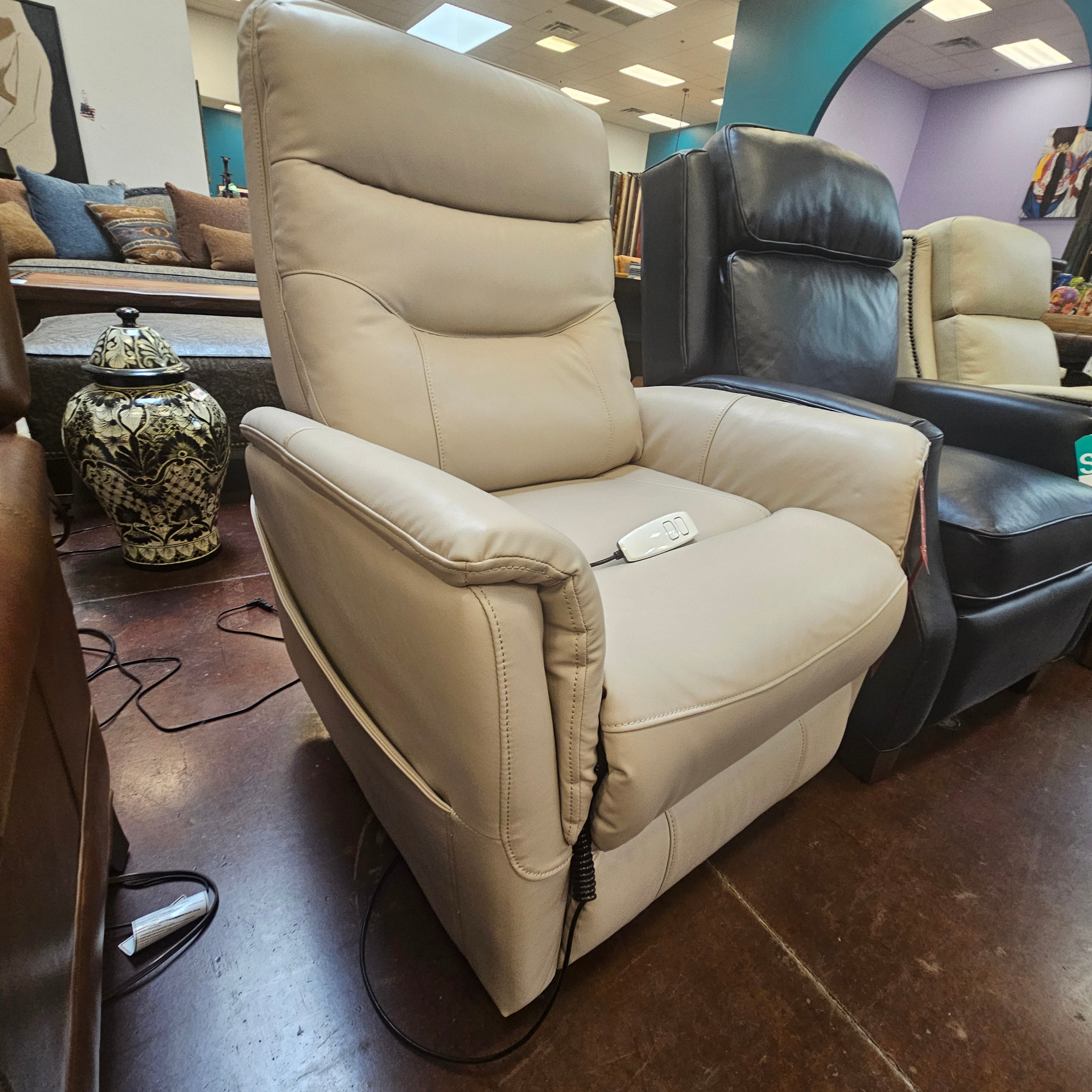 Beige recliner sofa in a room with other furniture.