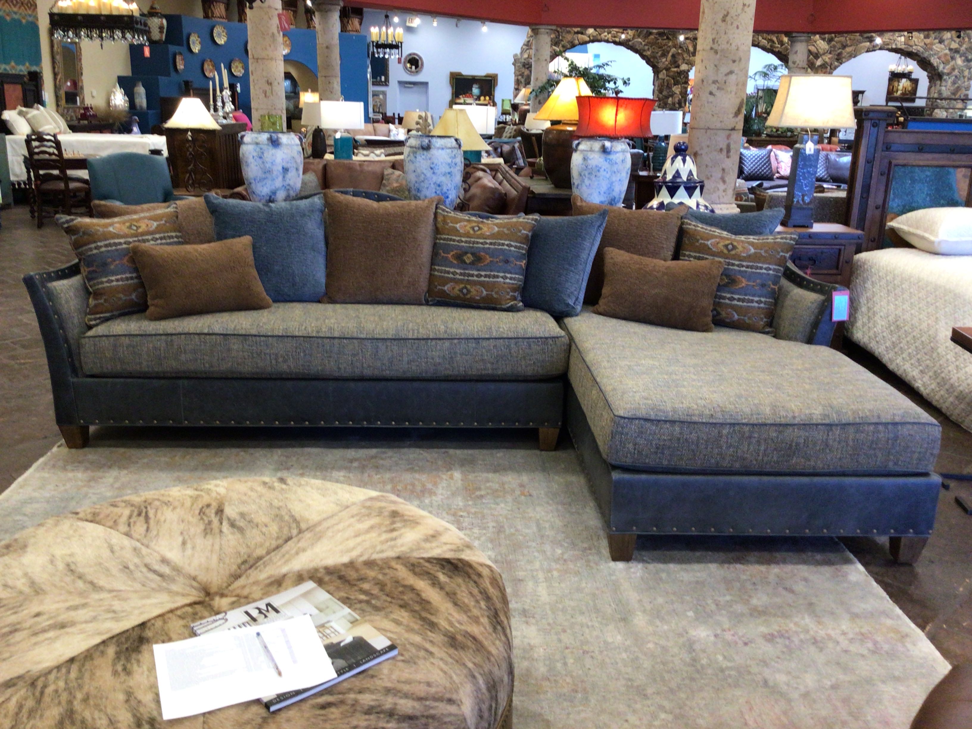 Sectional sofa with decorative pillows in a furniture store setting