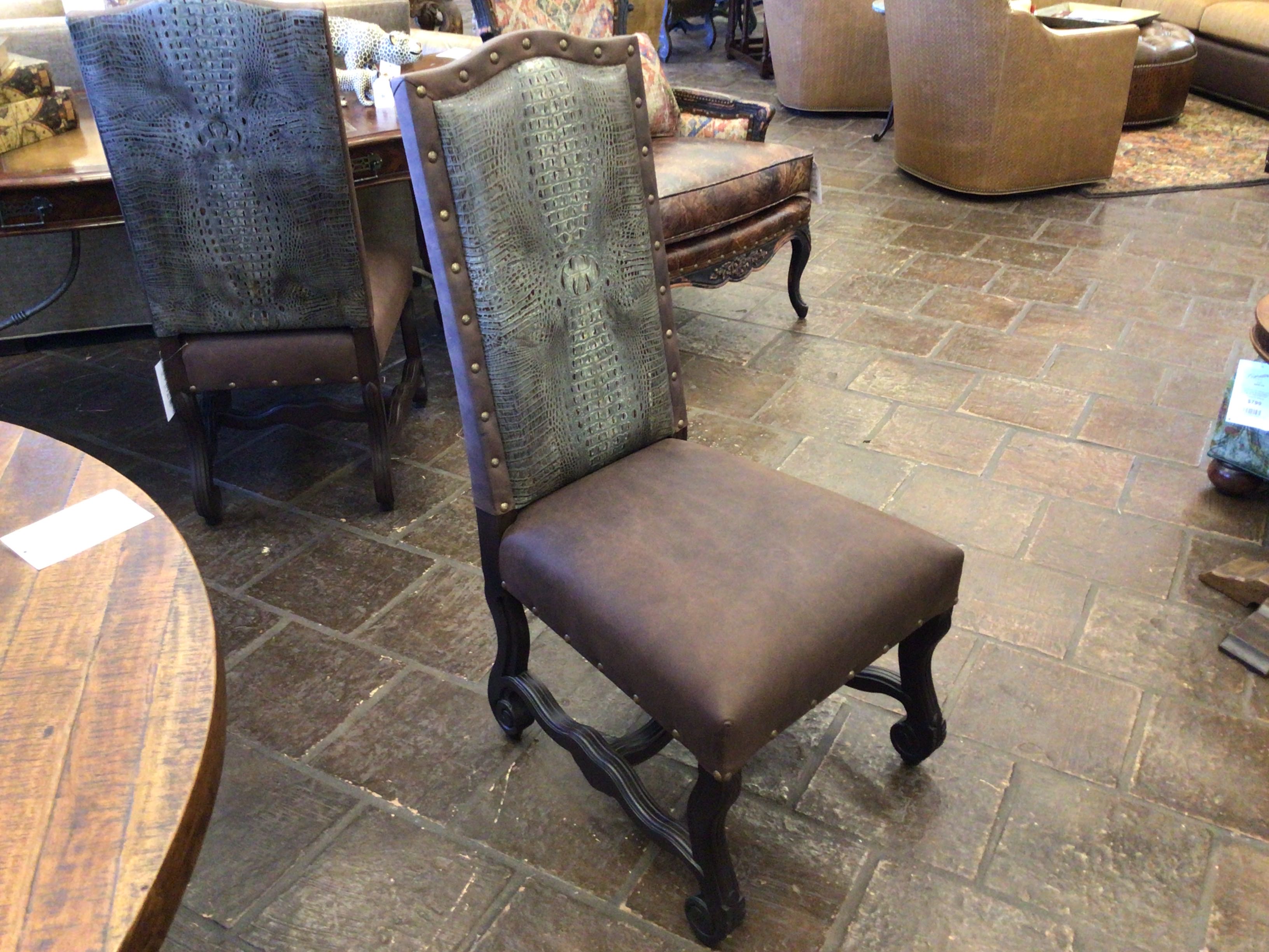 Brown upholstered chair with decorative backrest in a showroom setting