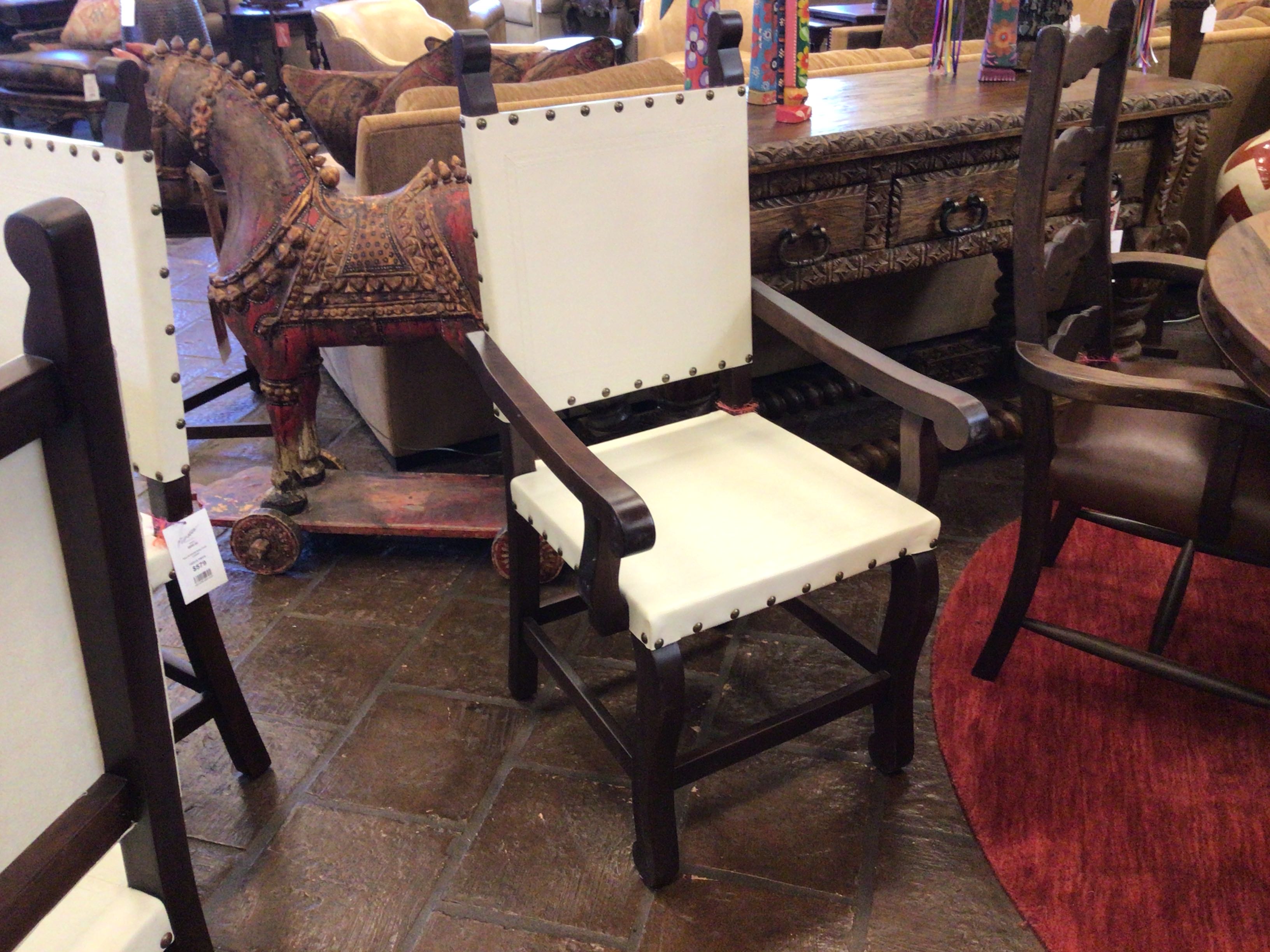 Wooden chair with white cushion in a furniture store setting