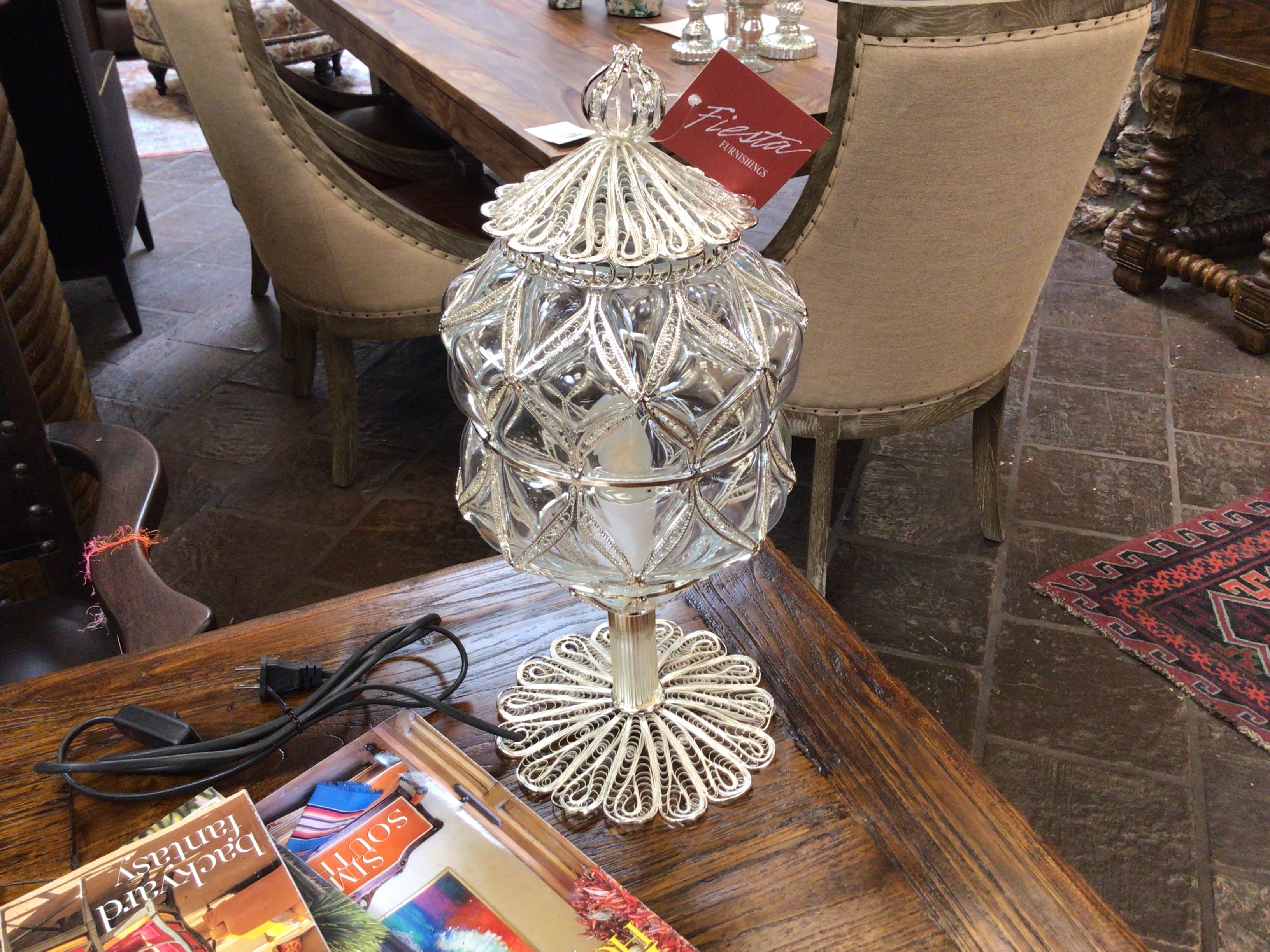 Decorative crystal lamp on a wooden table with books in a restaurant setting