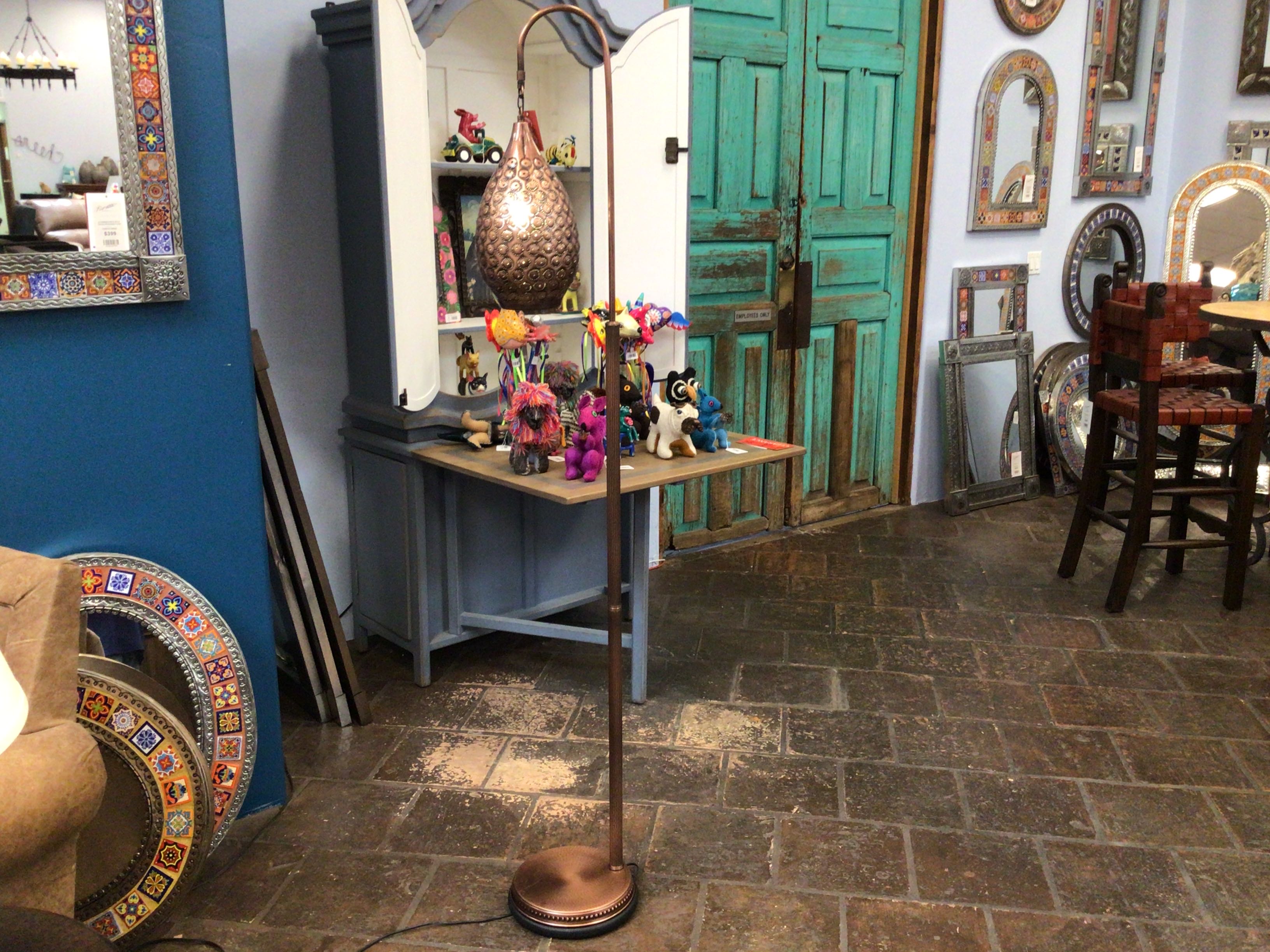 Room interior with decorative items, furniture, and a standing lamp.