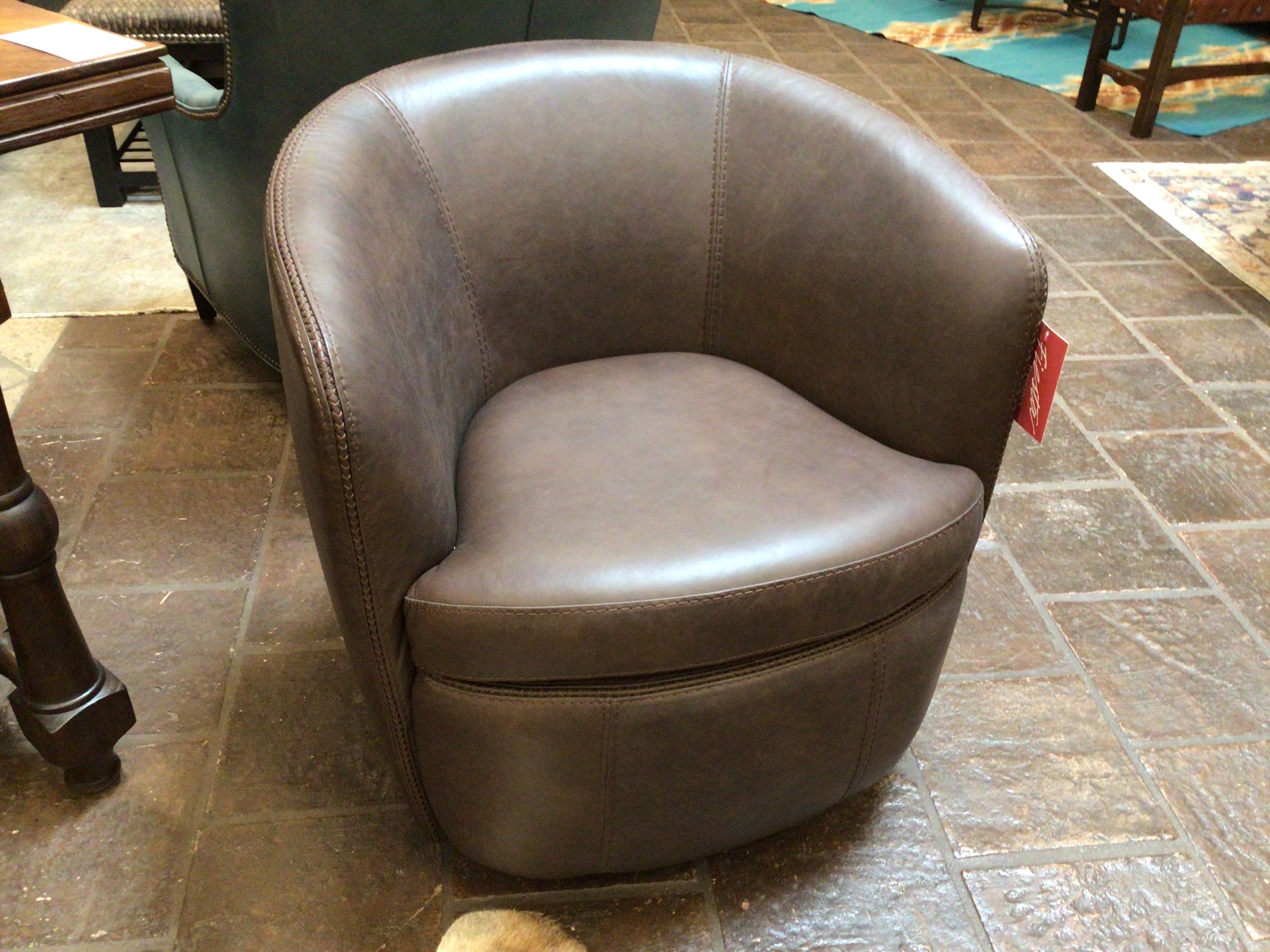 Brown leather chair on a stone floor