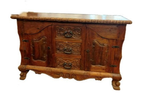 Wooden sideboard with intricate carvings on a white background