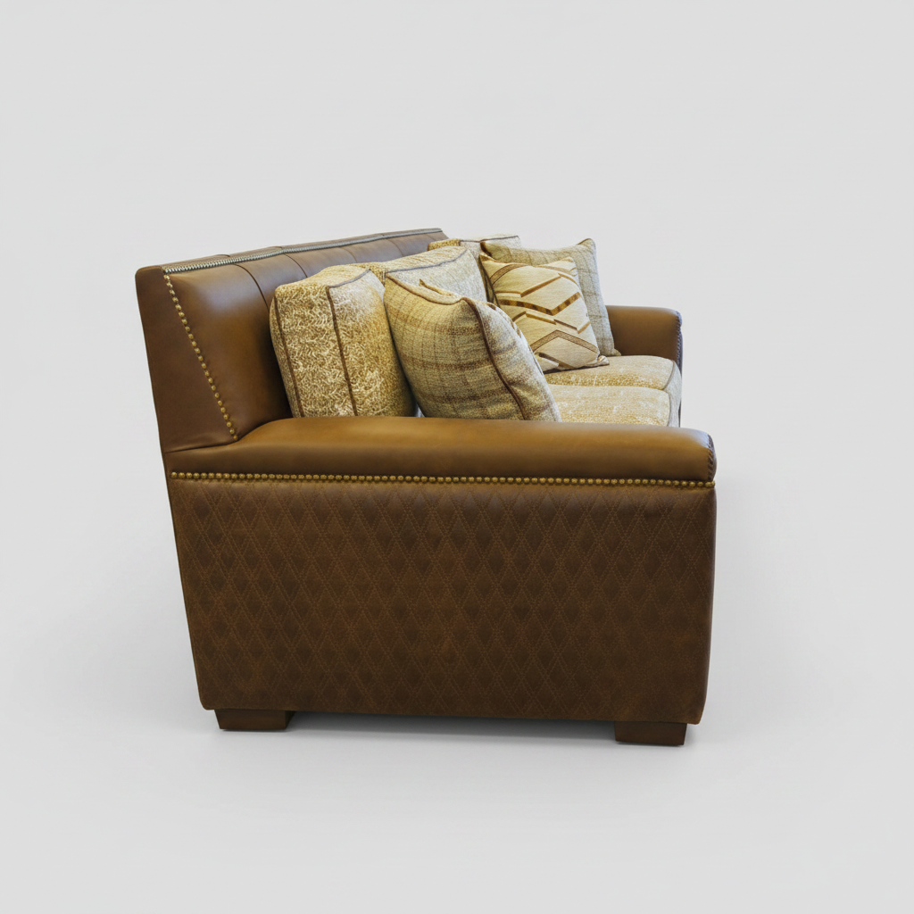 Brown leather and patterned fabric sofa with decorative pillows in a showroom setting.