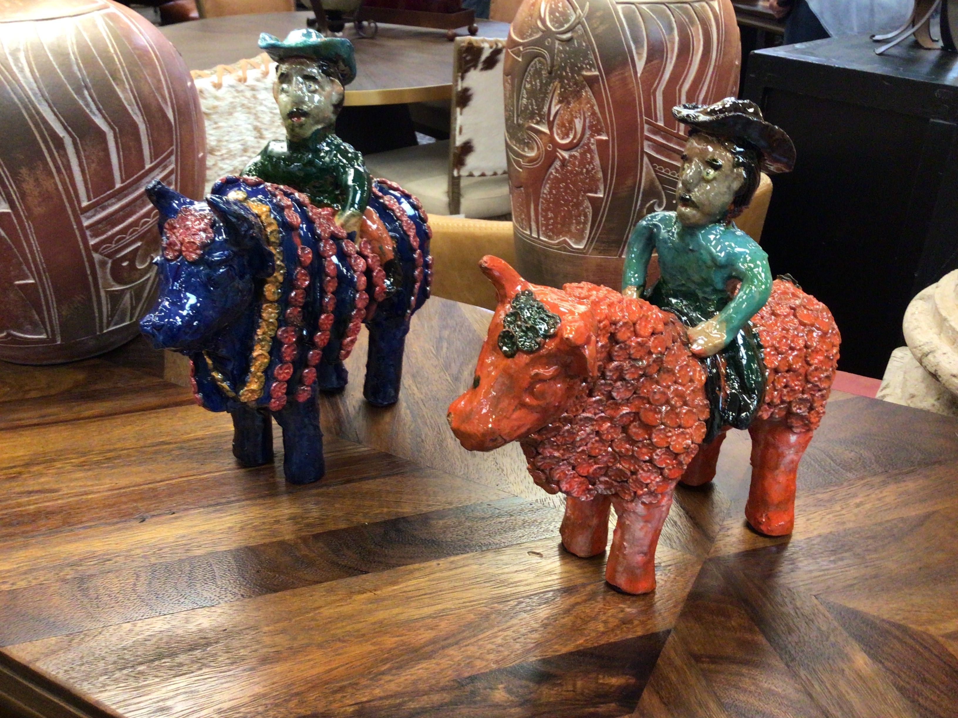 Decorative figurines of a horse and rider on a wooden surface