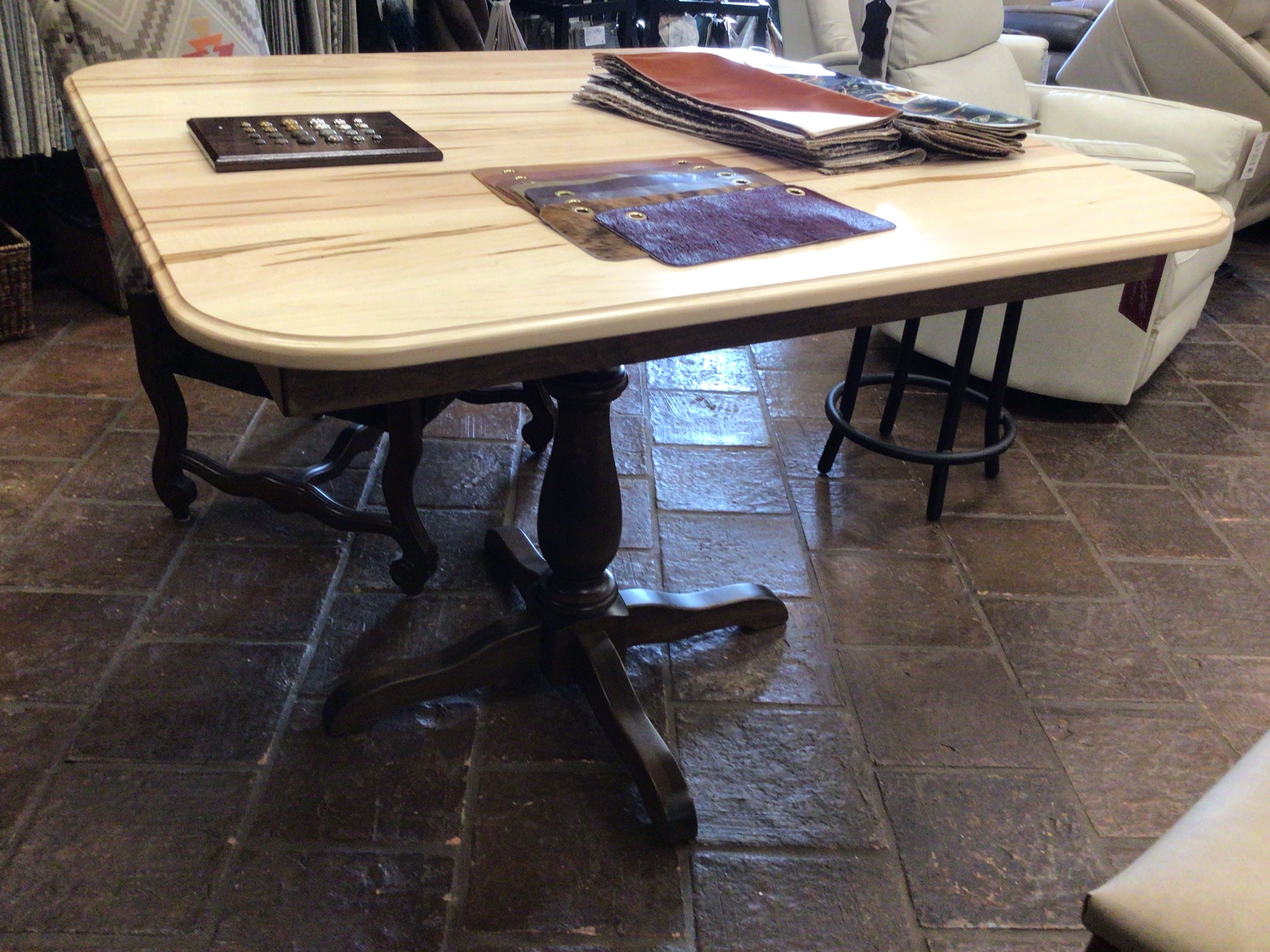 Wooden table with chairs on a tiled floor in a room setting