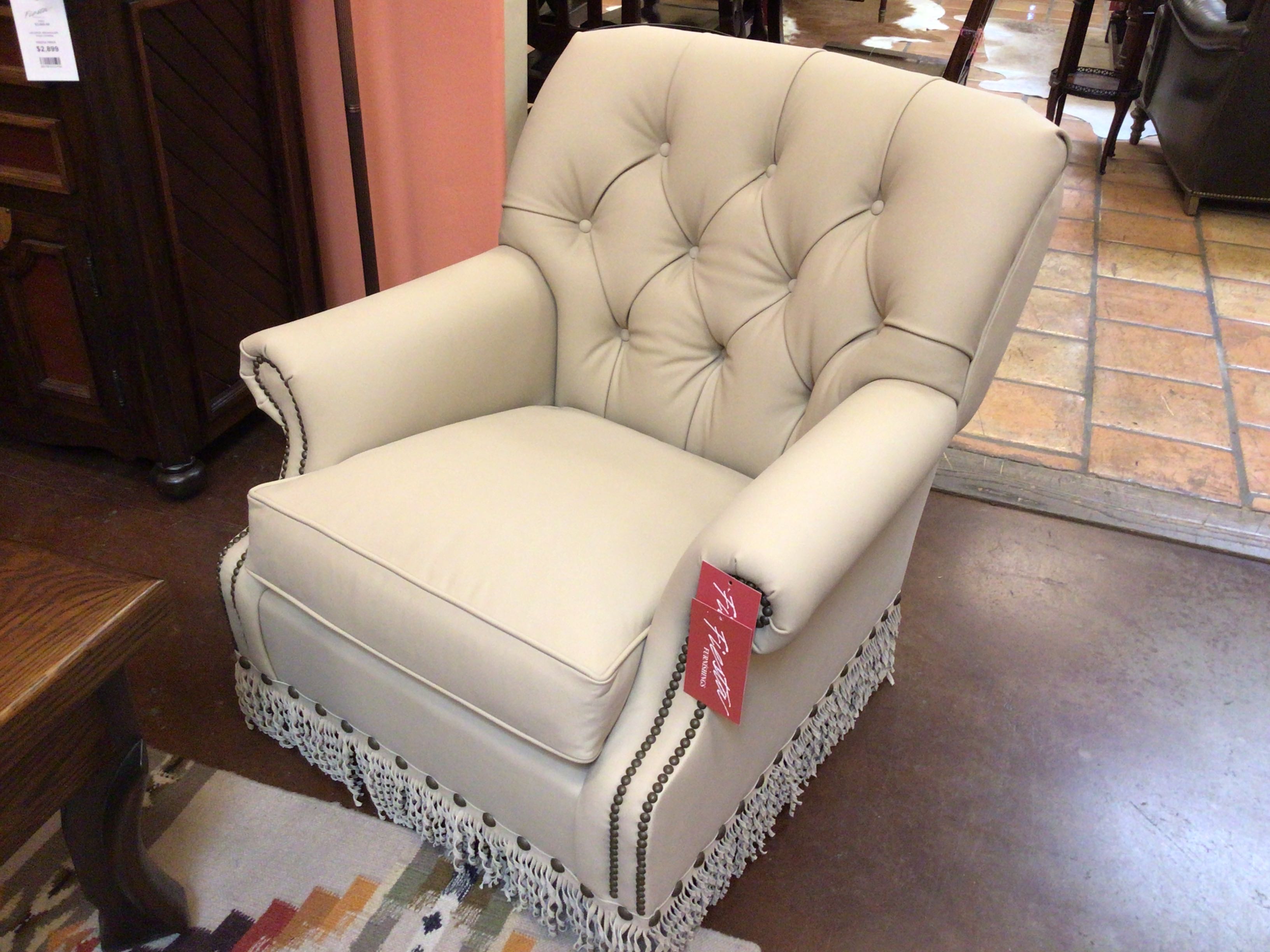 Beige armchair with a price tag in a store setting
