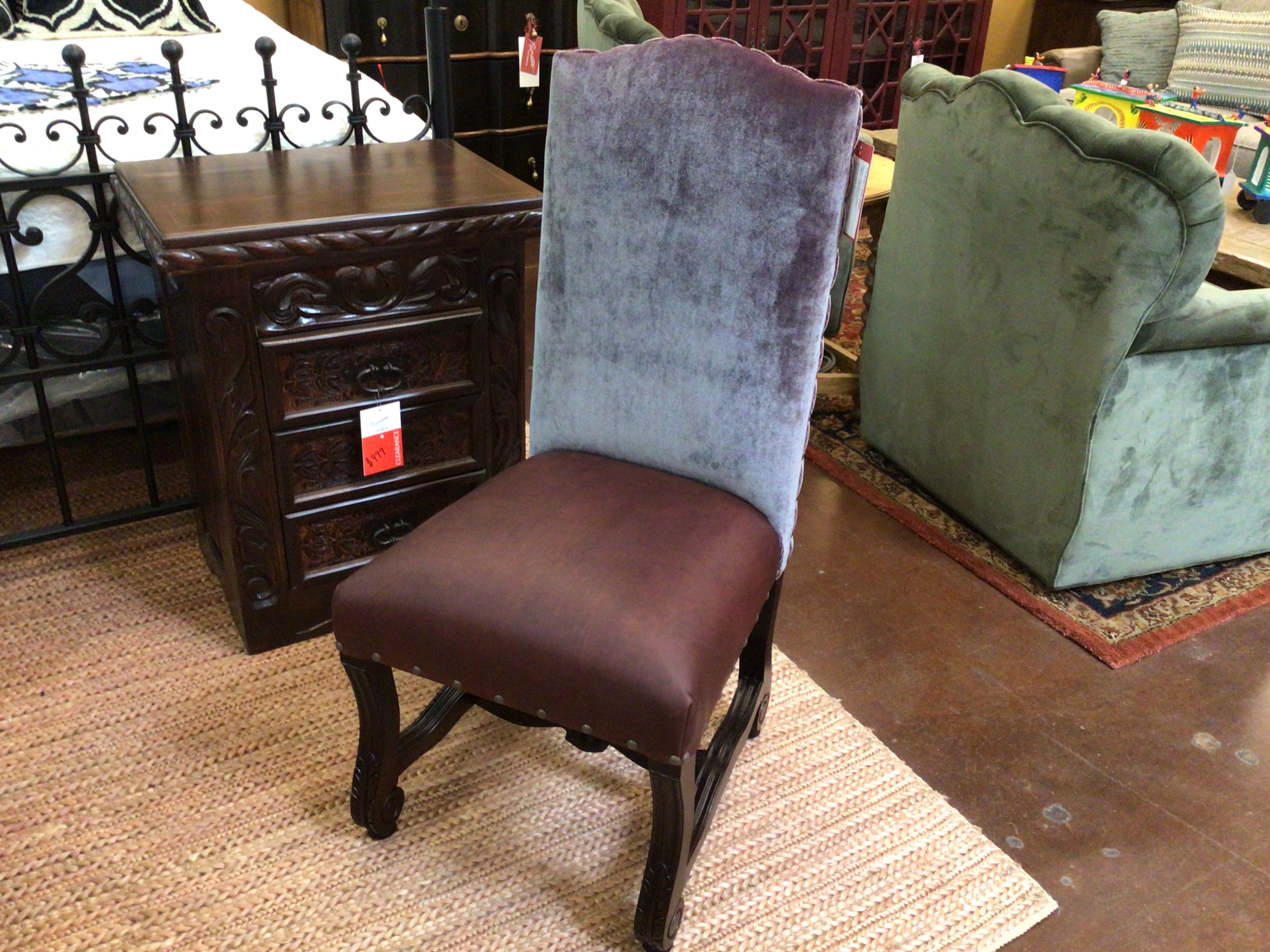 Chair with purple backrest and brown seat in a room with furniture and decor.