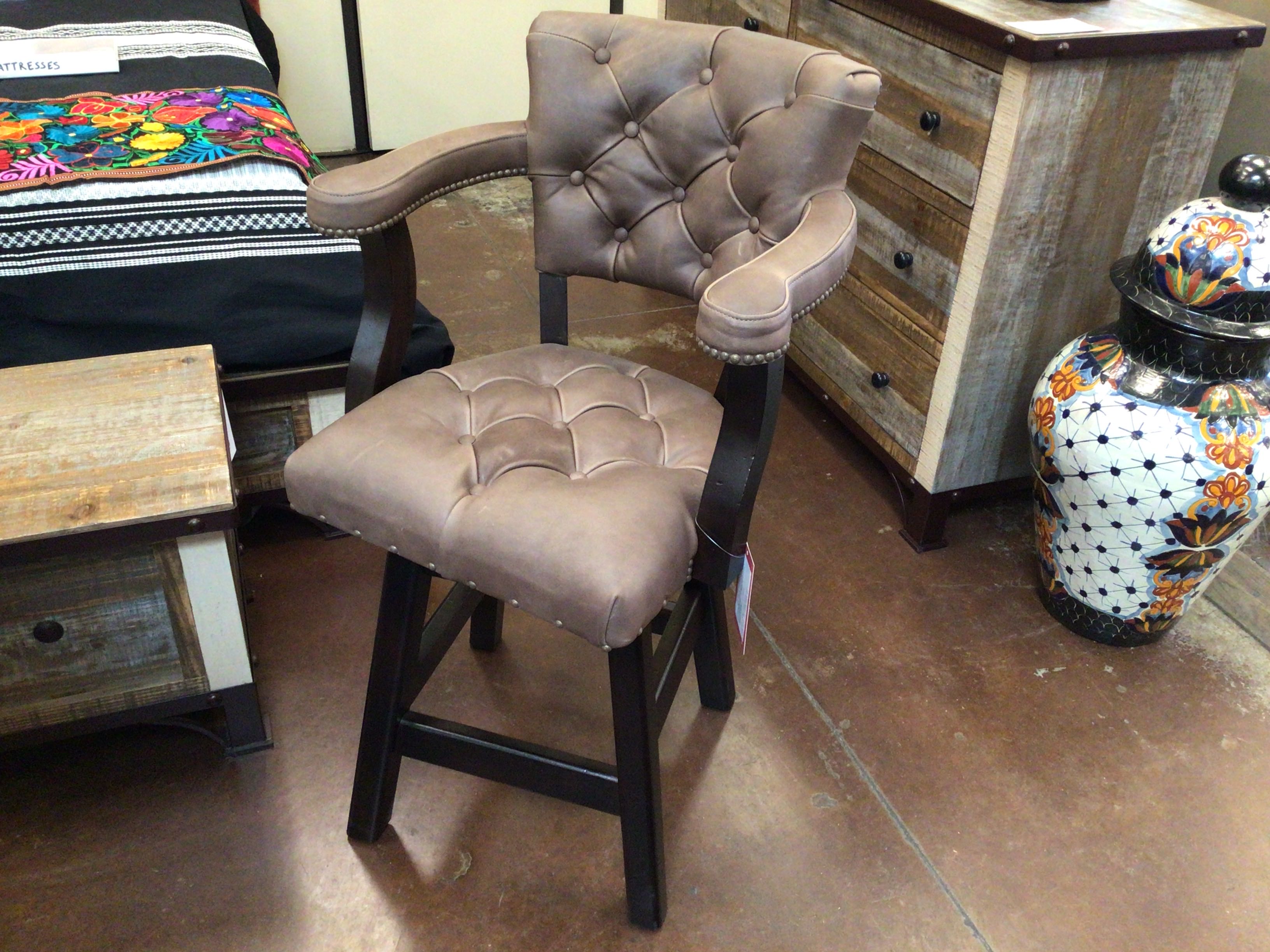 Brown cushioned chair in a room with wooden furniture and decorative items.