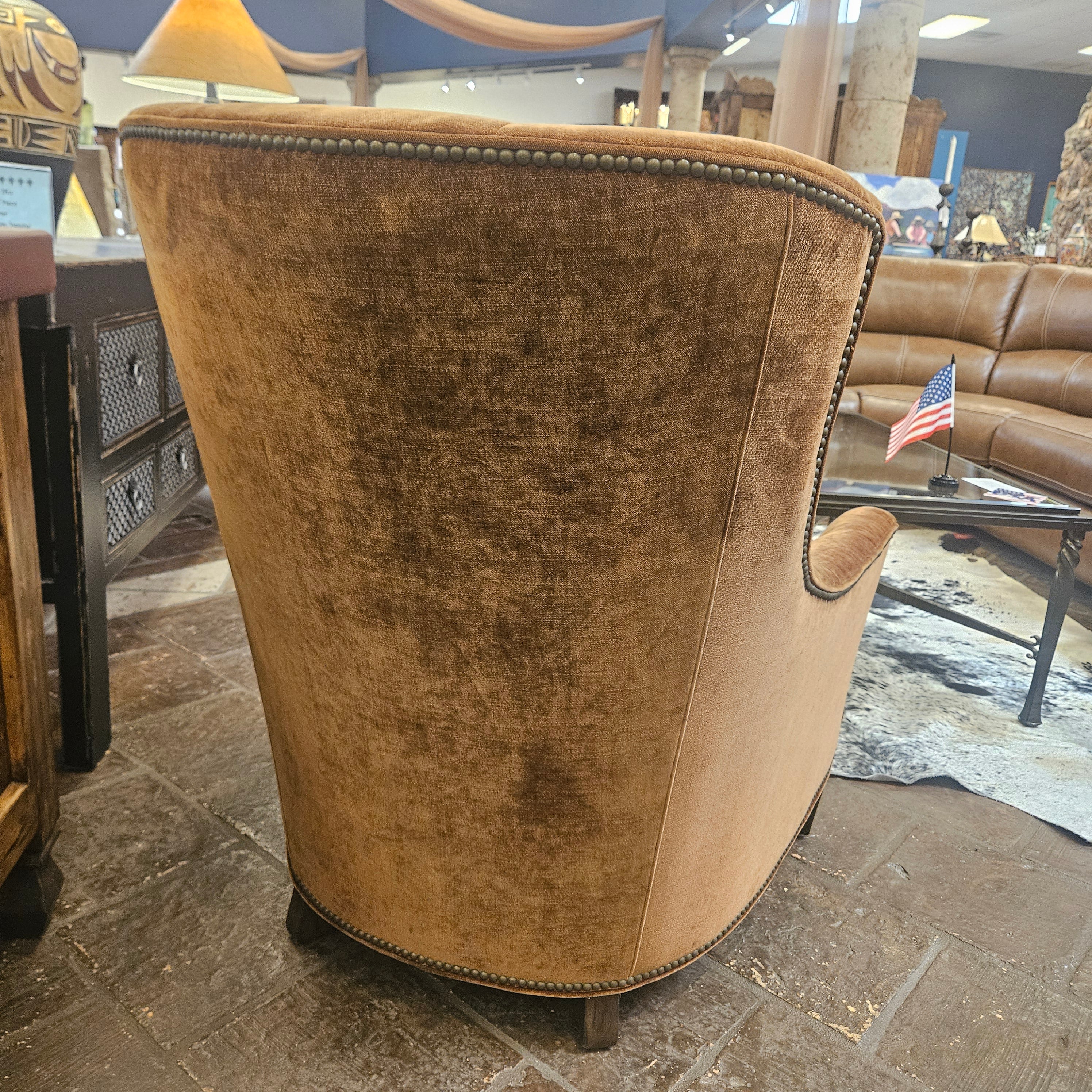 Brown fabric chair in a store setting.