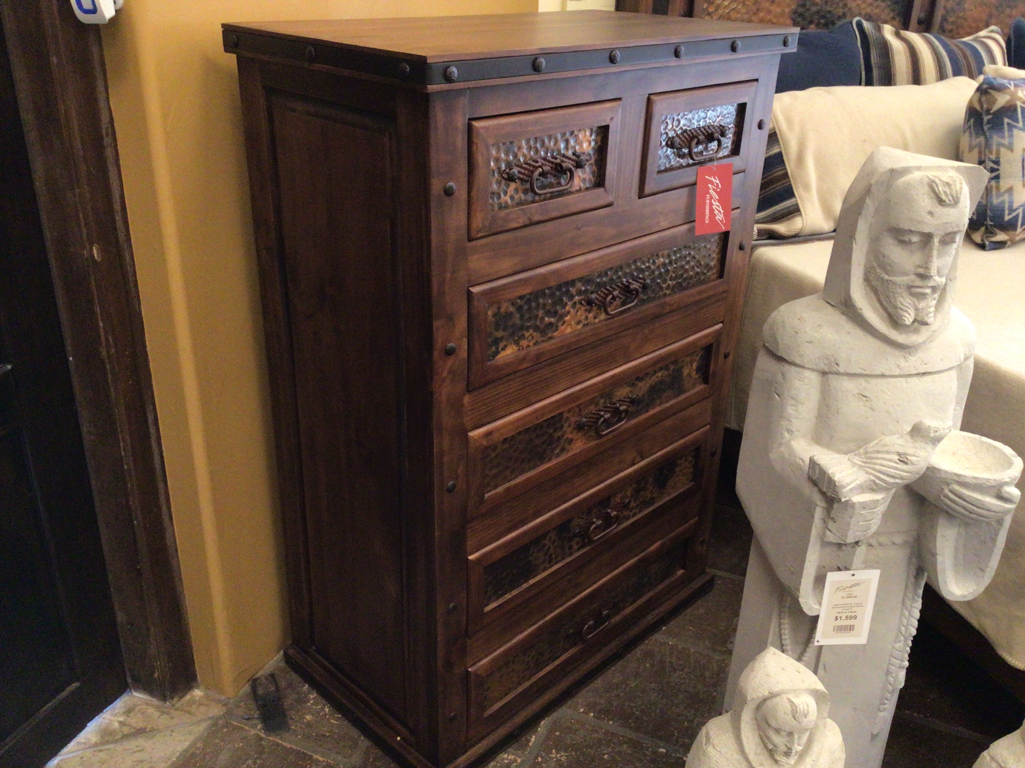 Wooden dresser with decorative panels in a store setting