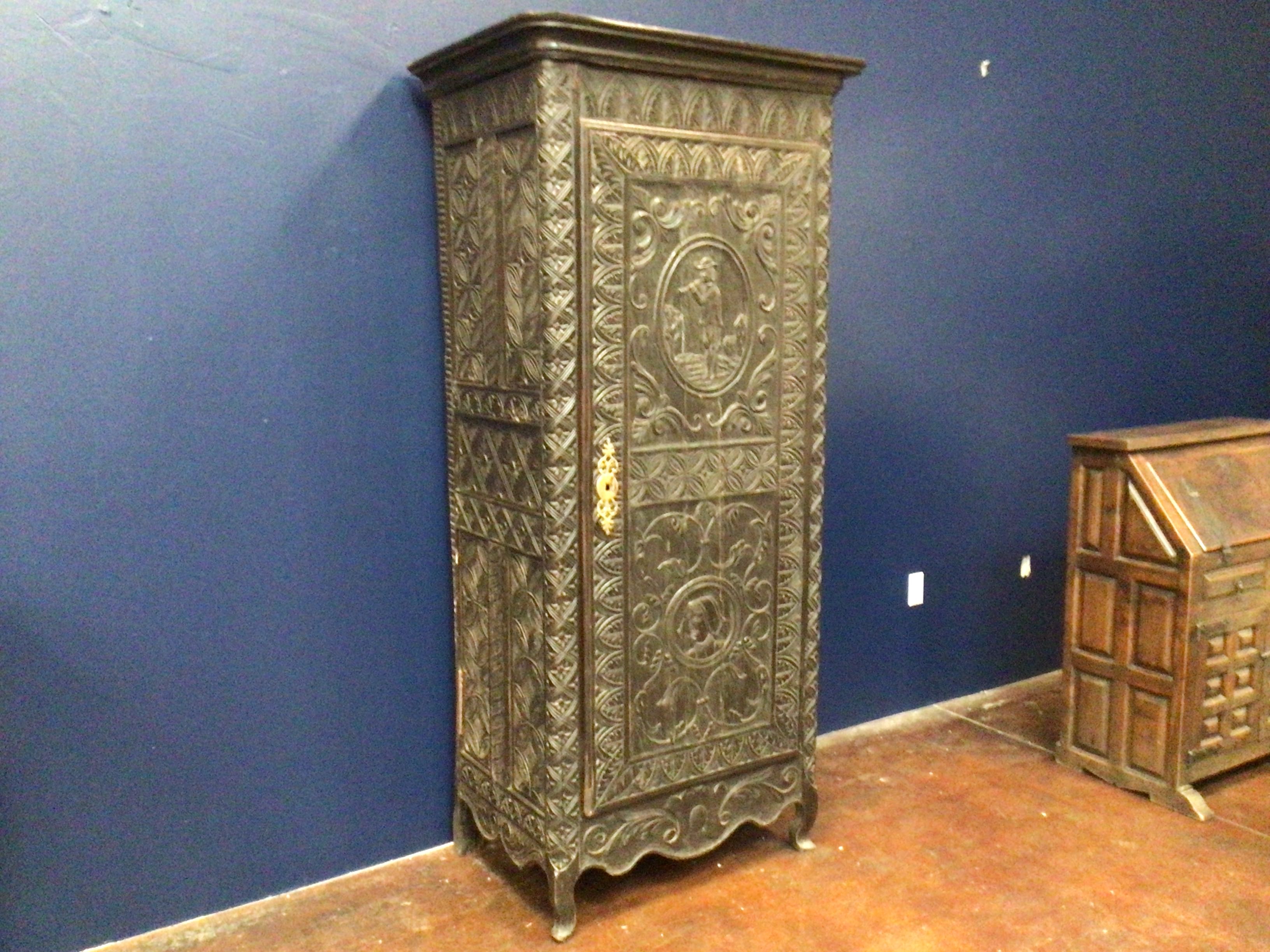 Decorative wooden cabinet against a blue wall
