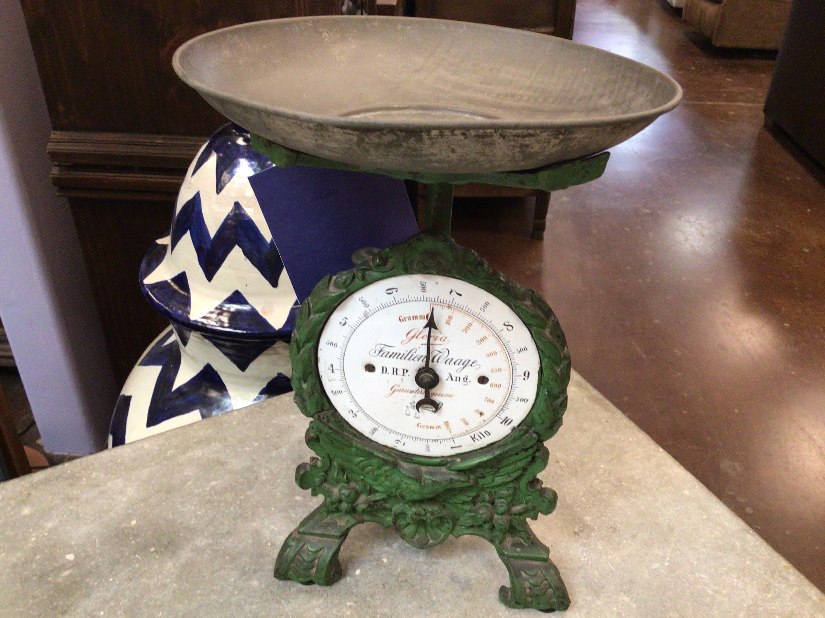Vintage green scale with a round dial on a surface