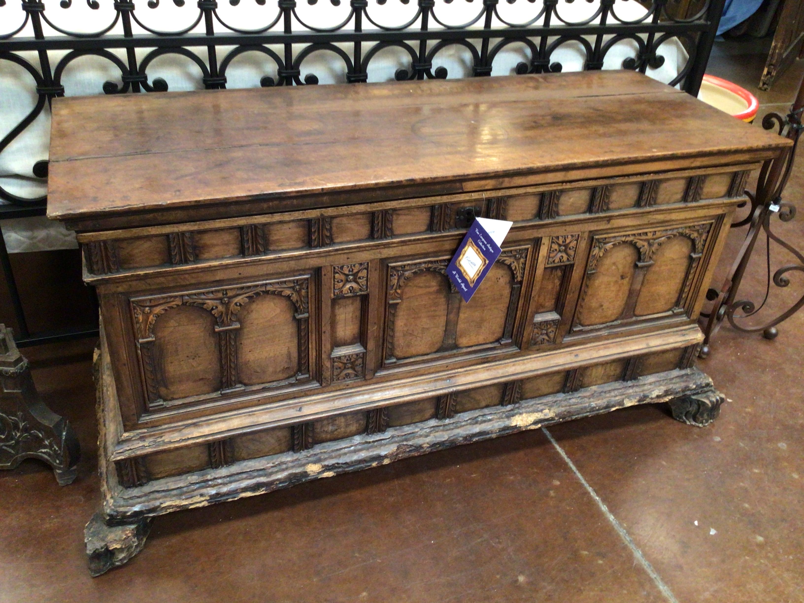 Wooden chest with intricate carvings on a tiled floor