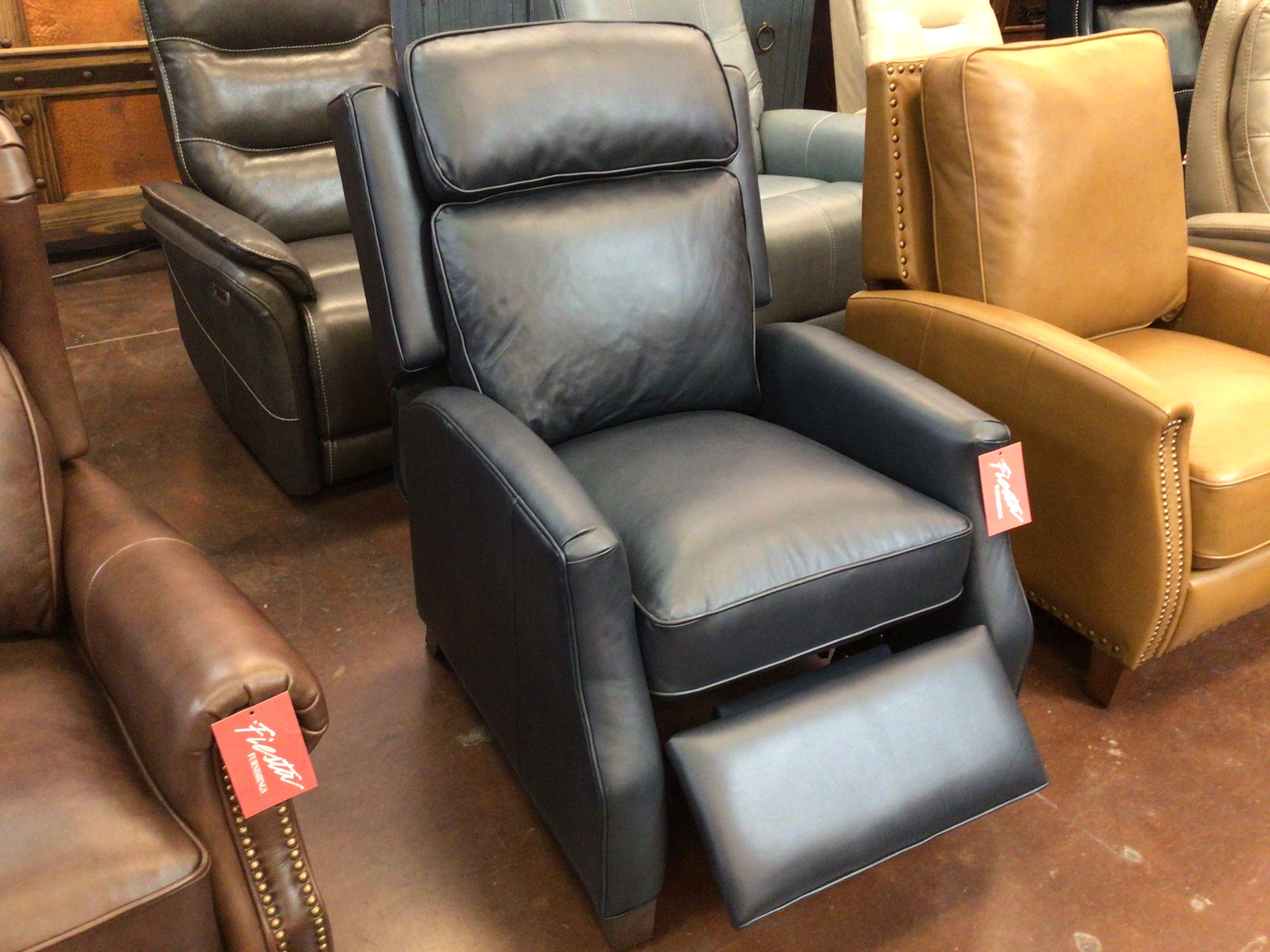 Leather recliner chairs in a showroom setting with tags on.