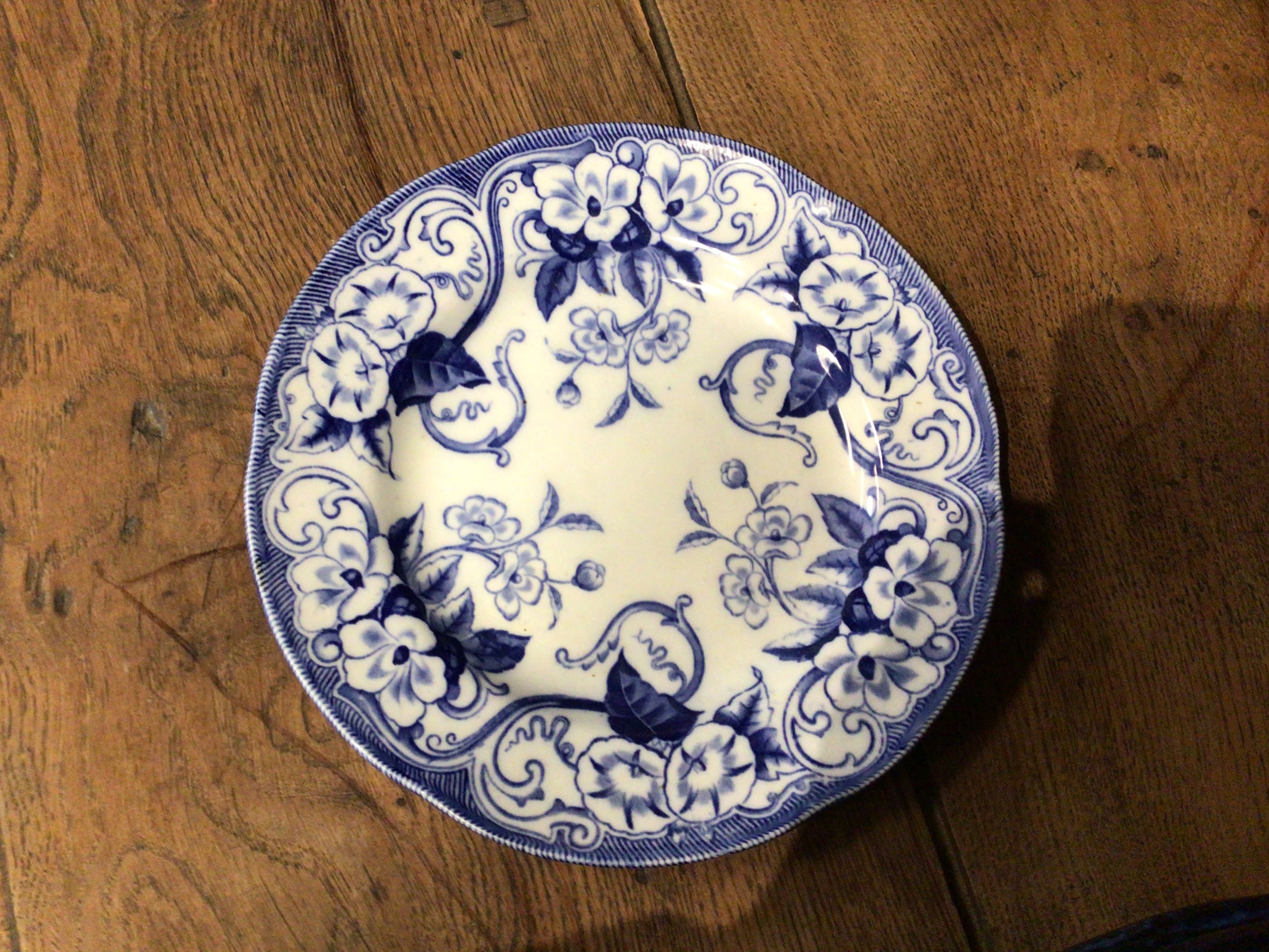 Blue and white decorative plate on a wooden surface