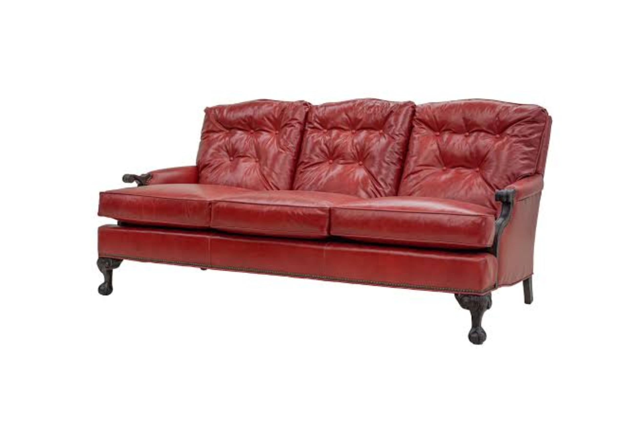 Red leather sofa on a white background