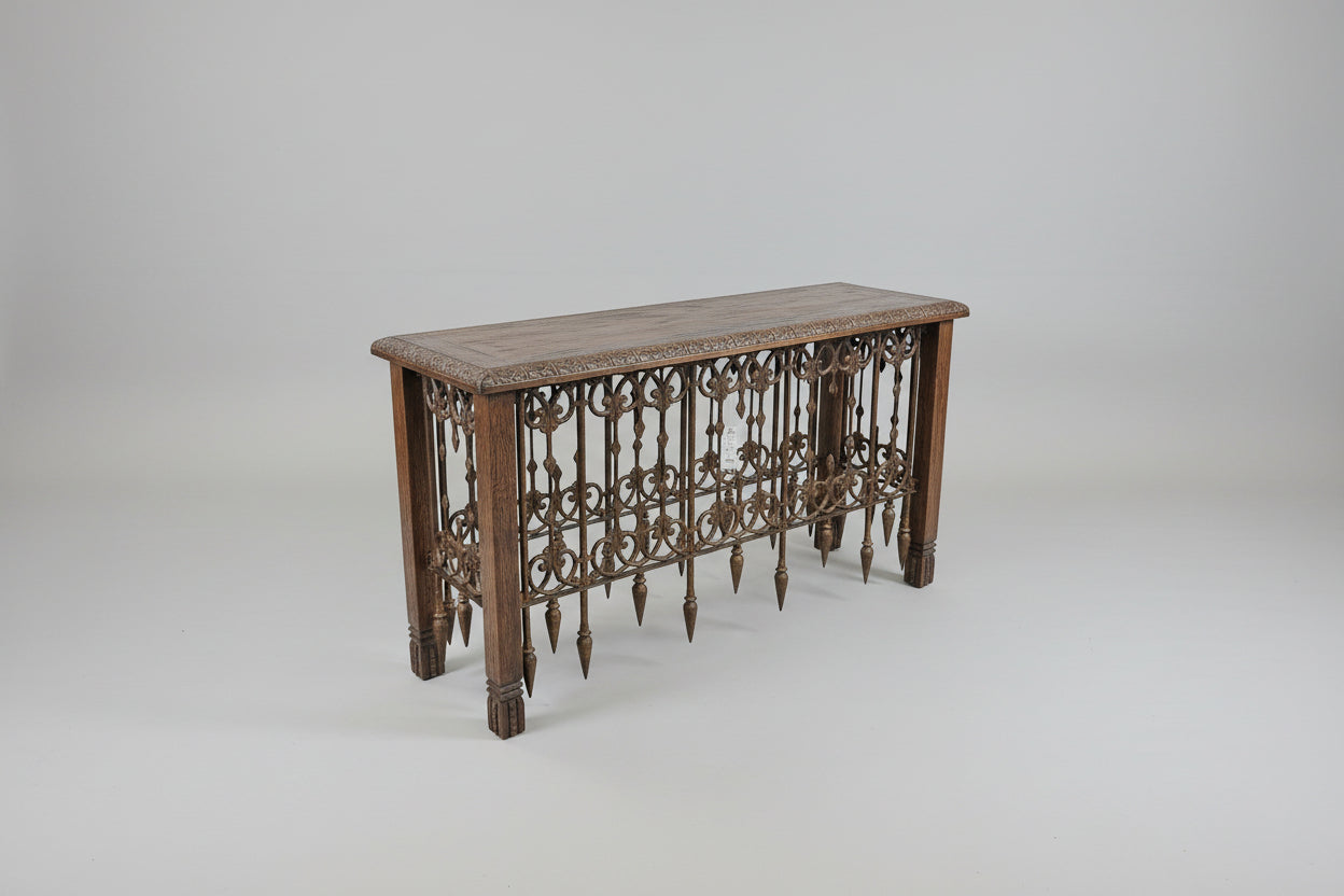 Wooden table with intricate carvings on a gray background