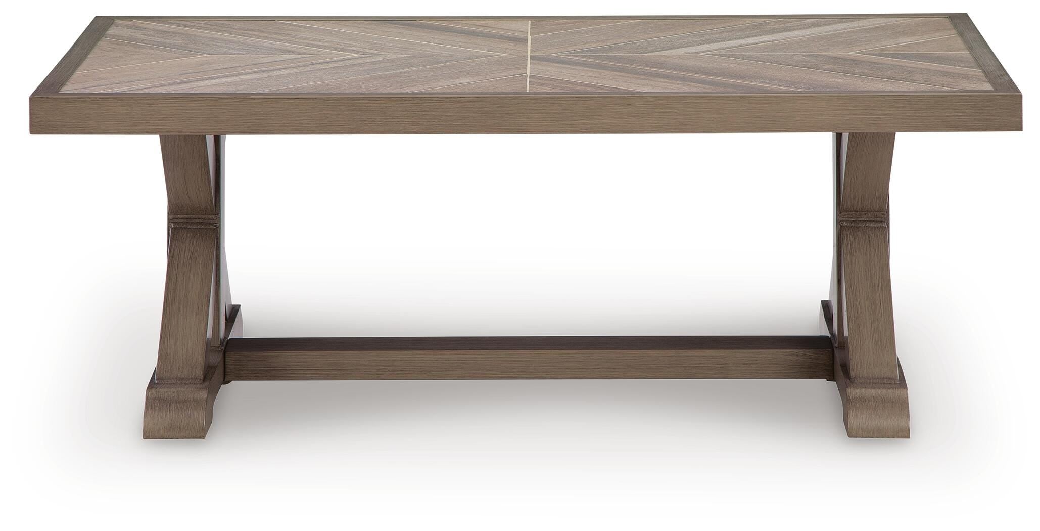 Wooden dining table with a chevron pattern on a white background