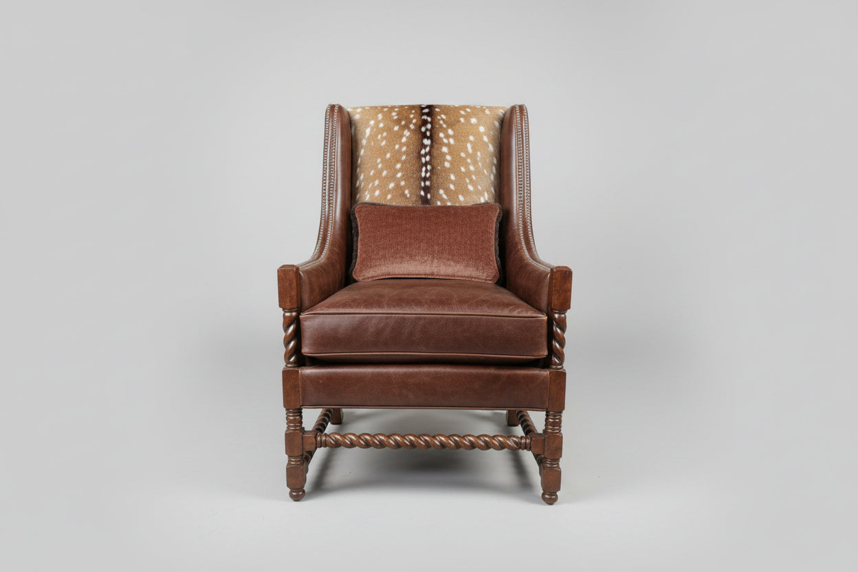 Brown leather armchair with a patterned backrest on a gray background