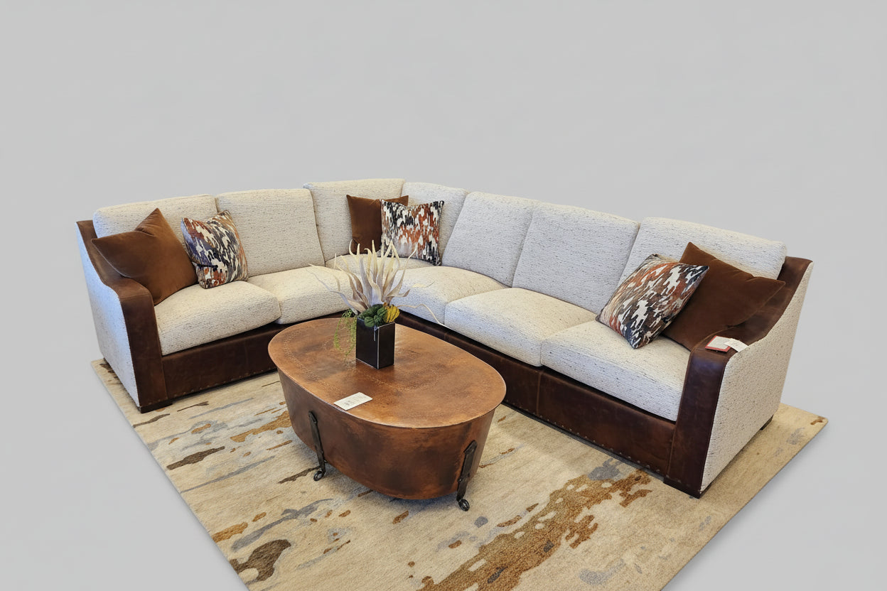 Sectional sofa with brown and beige cushions on a neutral background