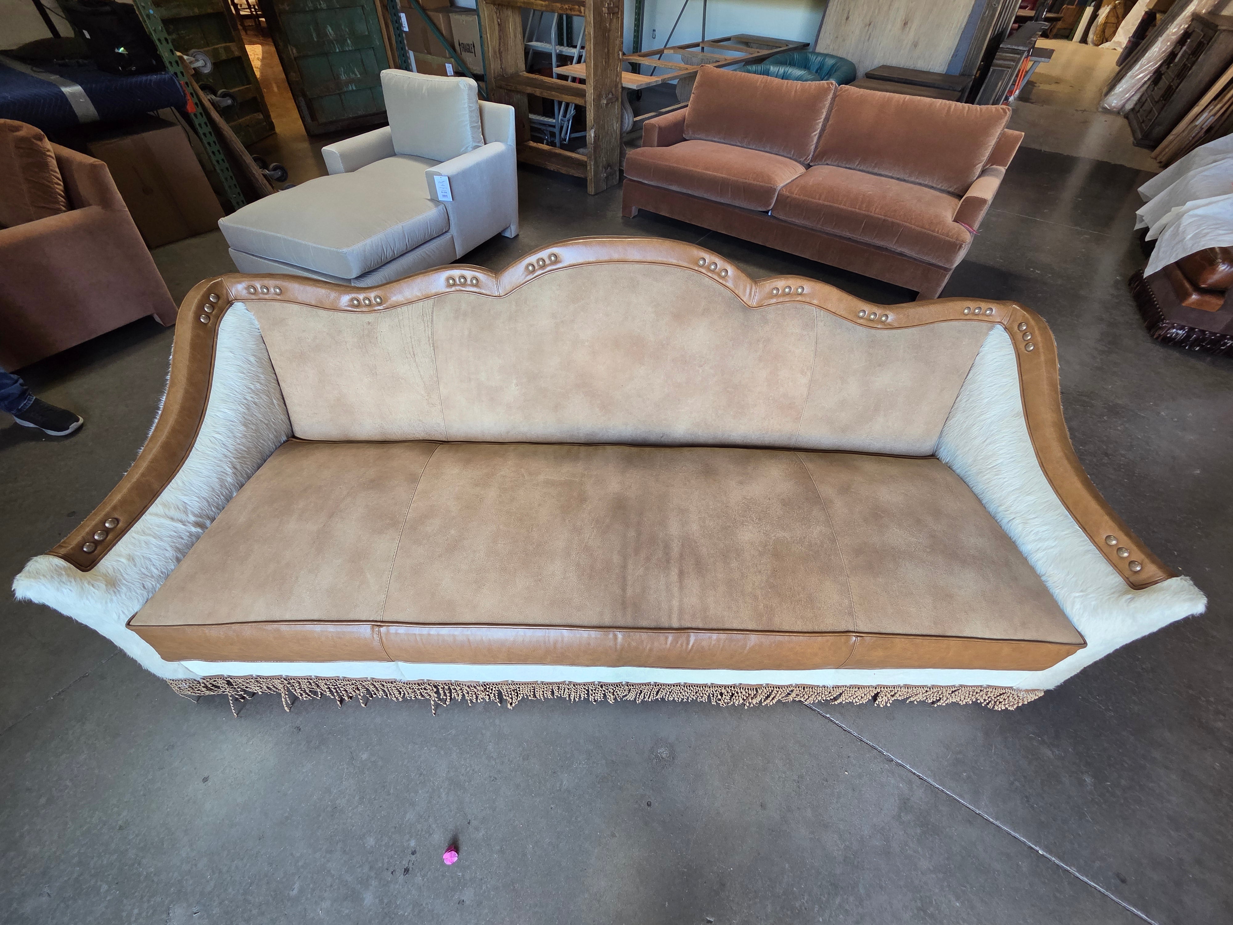 Vintage-style sofa with decorative elements in a warehouse setting