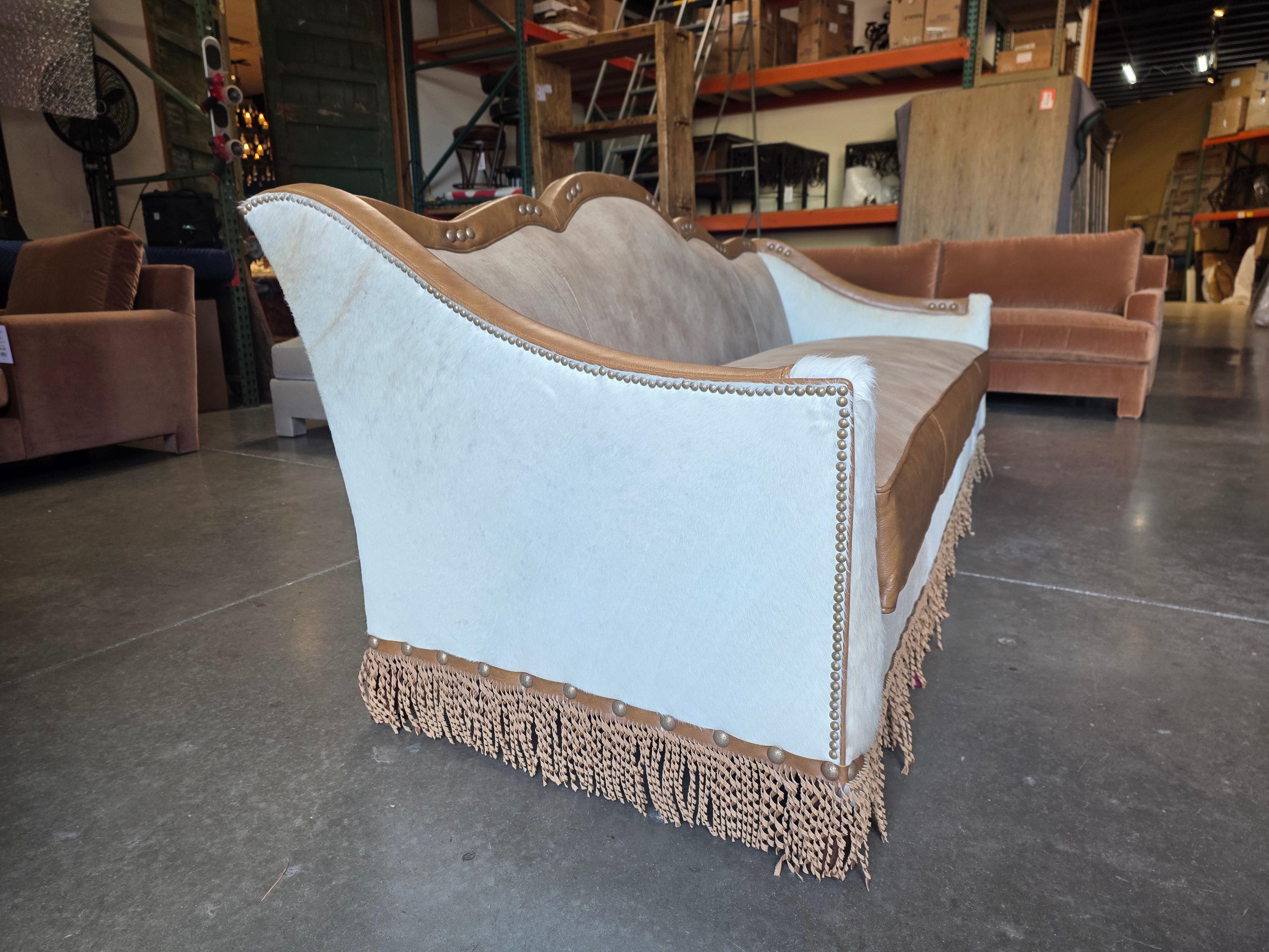 Decorative sofa with fringe details in a warehouse setting