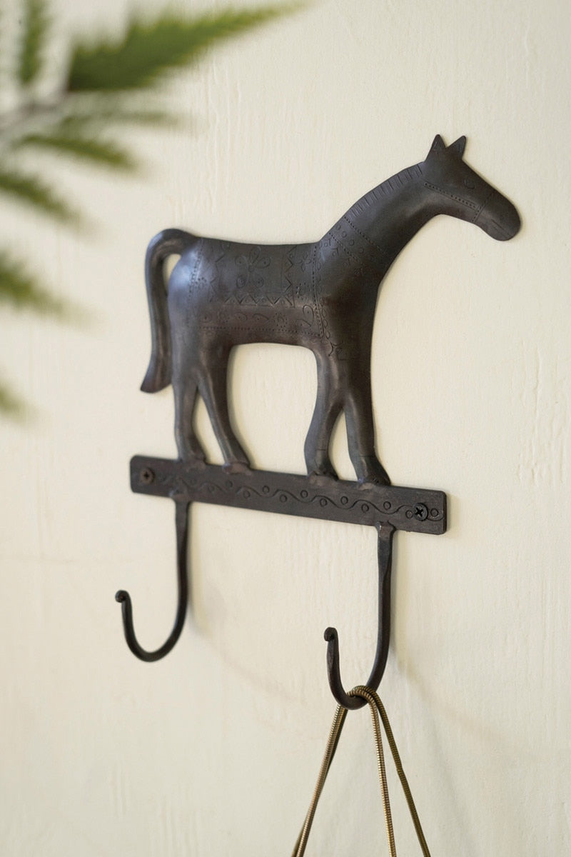 Decorative wall hook shaped like a horse on a light background