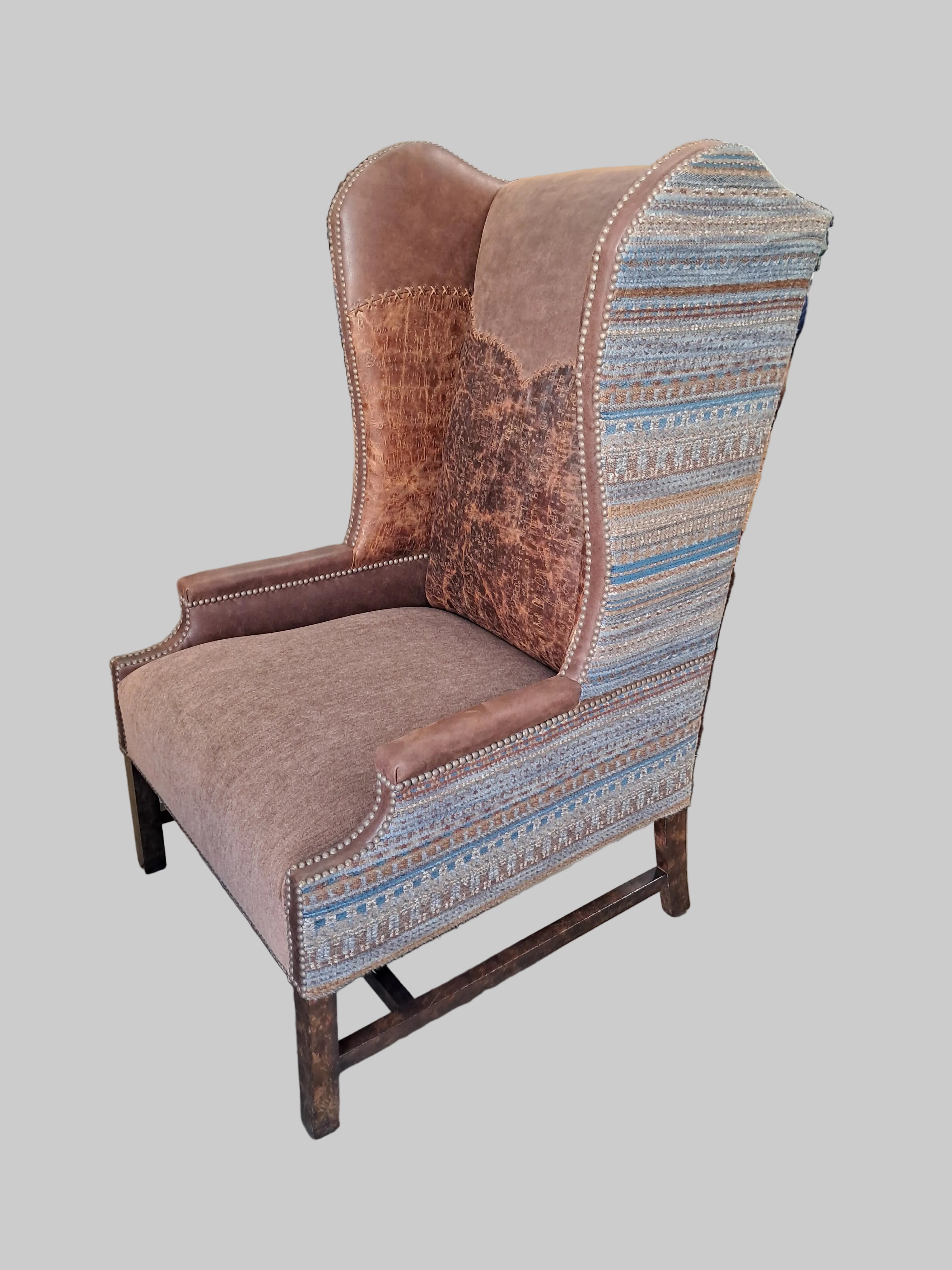Brown and patterned fabric ottoman on a concrete floor with various items in the background