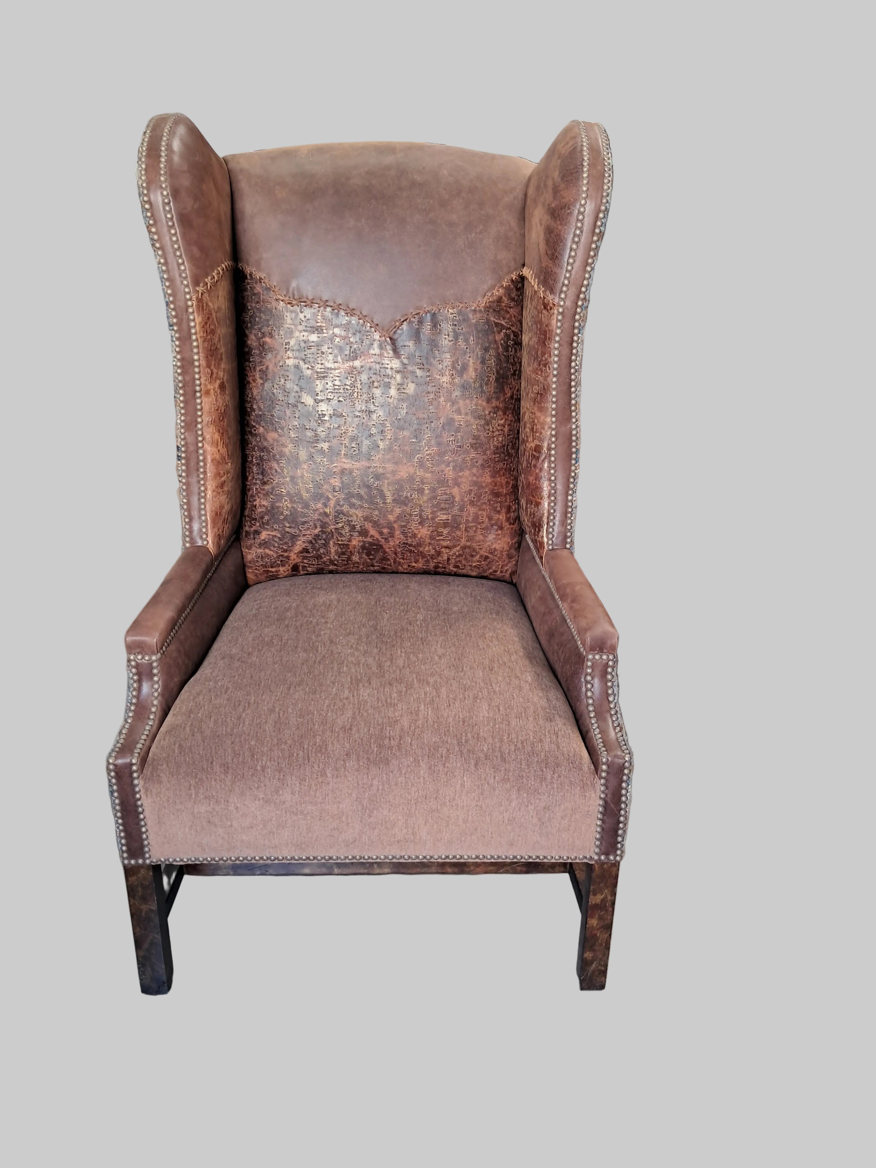 Brown leather chair with visible wear in a cluttered room