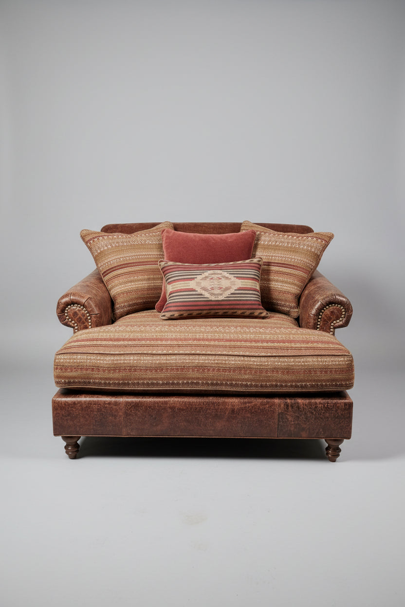 Patterned armchair with decorative cushions on a gray background