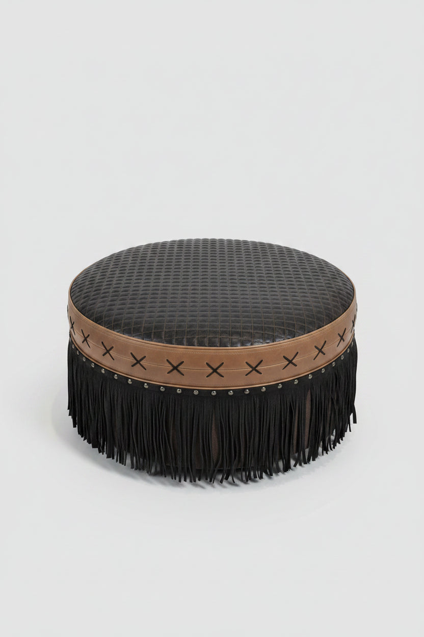 Round ottoman with textured cushion and fringe trim in a room setting