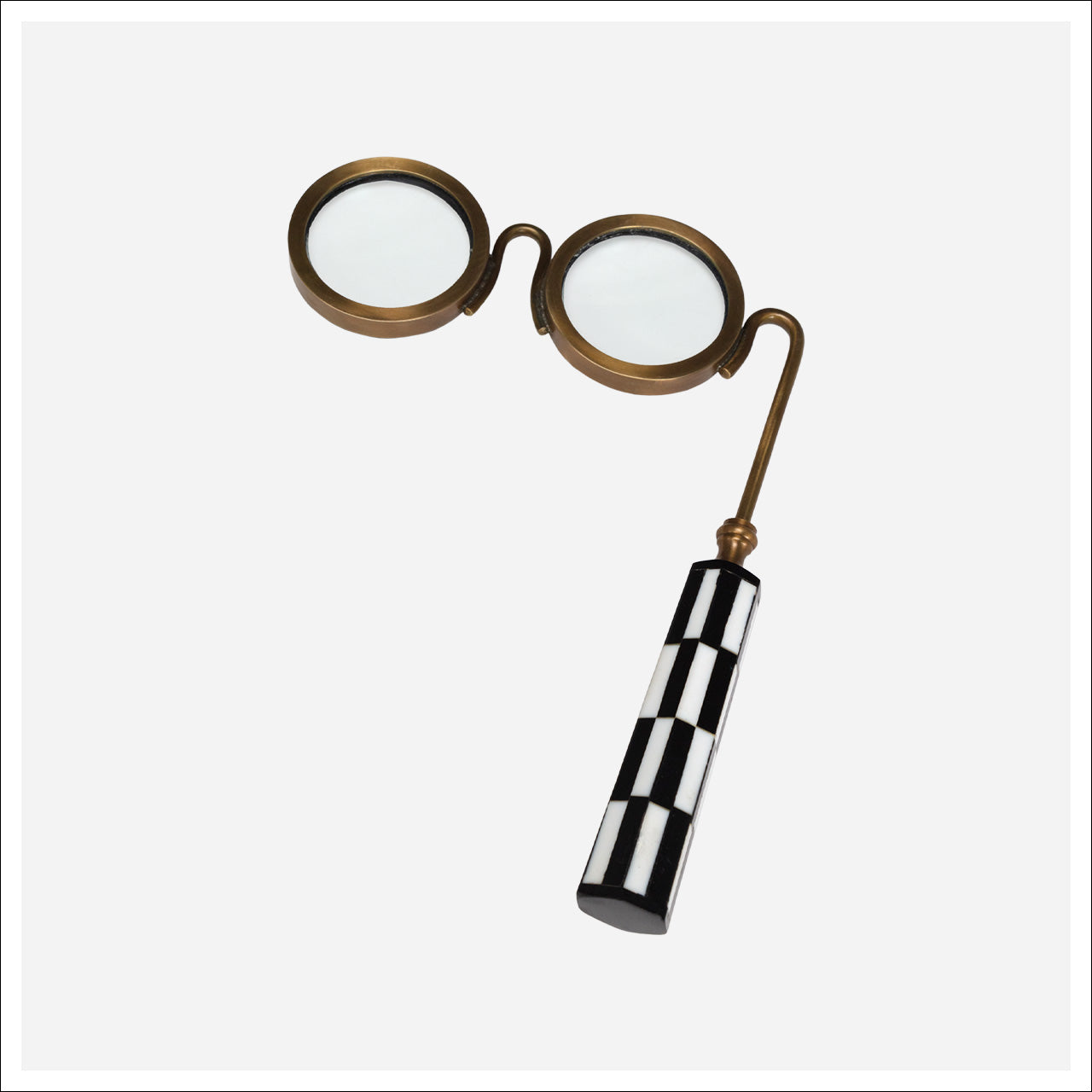 Vintage-style magnifying glass with checkered handle on a white background