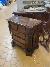 Italian walnut chest of drawers with paneled fronts and carved scroll side supports
