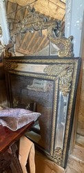 Napoleon III mercury glass mirror in a black lacquered frame with brass ornament