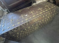 Leather trunk covered in brass studs forming dense fleur de lys motifs