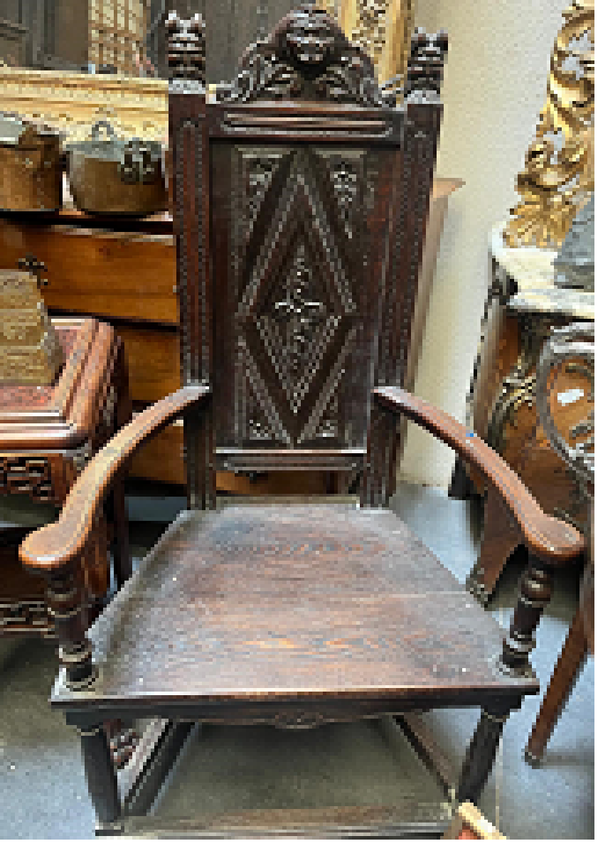 Pair of Henri II neo-Gothic oak armchairs with carved figural crests and diamond point backs