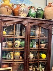 Seventy Provencal terracotta and glazed pottery jars in mixed sizes, greens and yellows