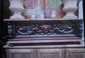 Neo-Gothic oak cabinet with a carved frieze of confronting griffins around a cartouche