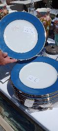 Twelve Limoges porcelain dinner plates with wide cobalt blue borders and white centers