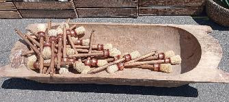 Forty turned wooden brush handles and bobbins in pale beech and rust stained timber