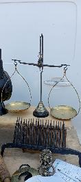 18th century balance scale with brass pans suspended from an iron beam and maker stamp
