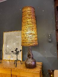 1970s table lamp with a conical wool wound shade over an amber stoneware bottle base