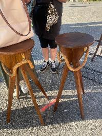 Pair of oak tripod stools with round dished seats and splayed legs in warm timber
